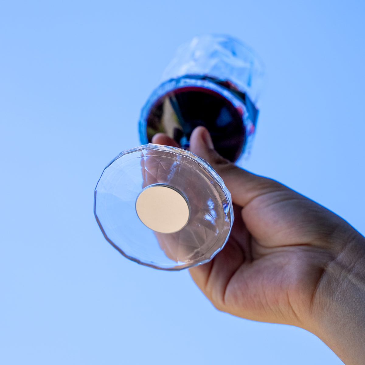 Magnetic plastic glass champagne filled with magnet in the bottom in the air