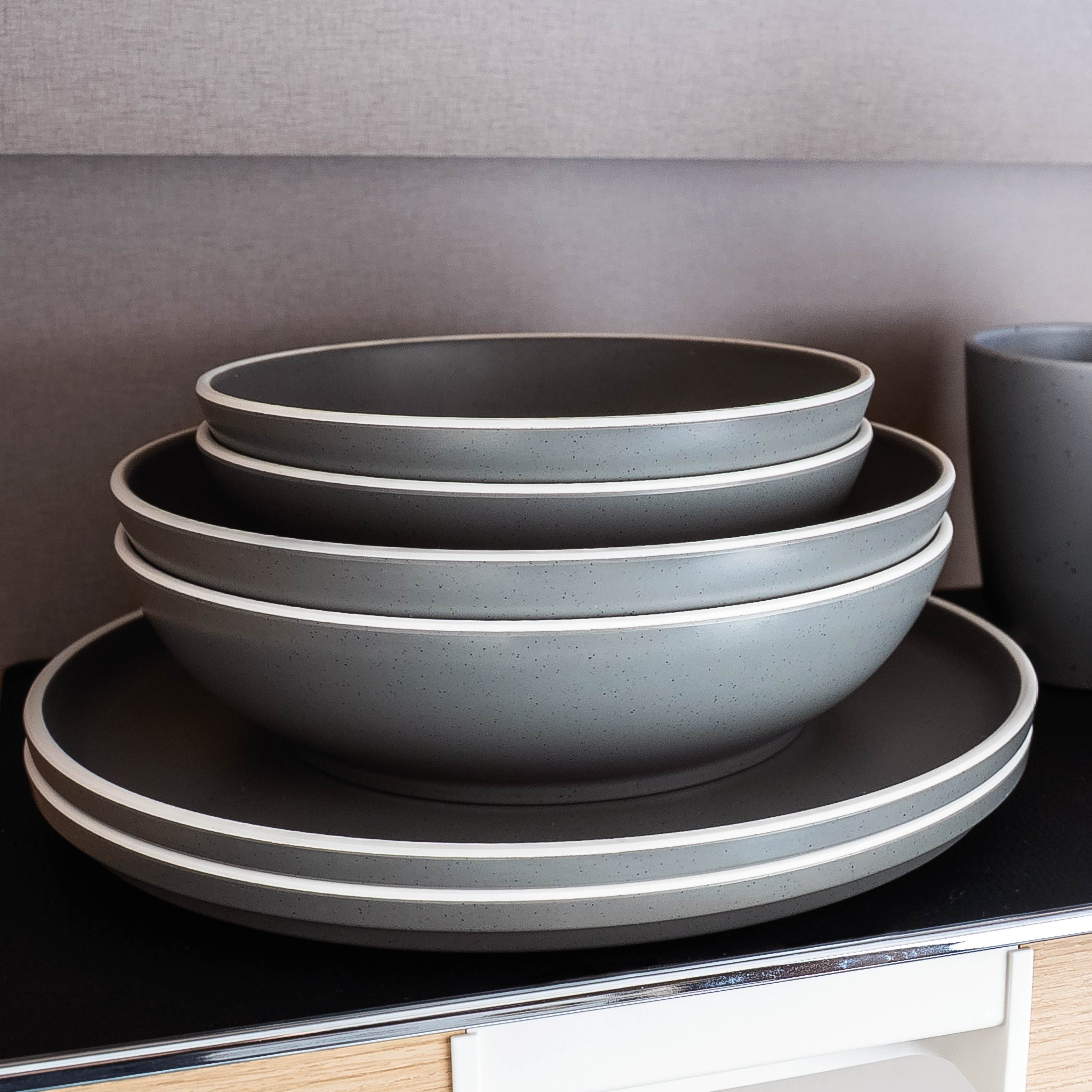 Grey plastic crockery set on mat in the camper