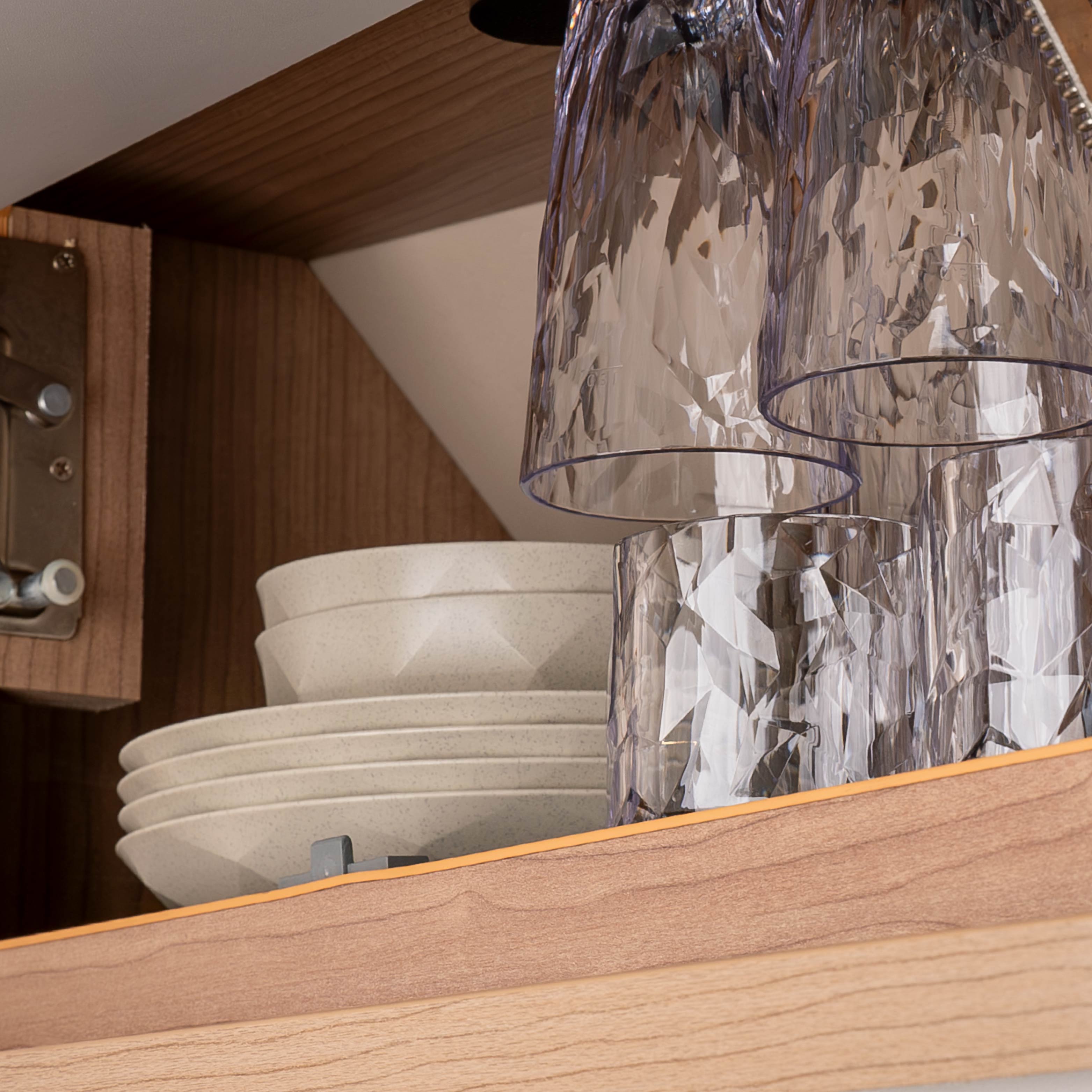 Magnetic tableware stowed away in a cupboard on a metal mat to save space