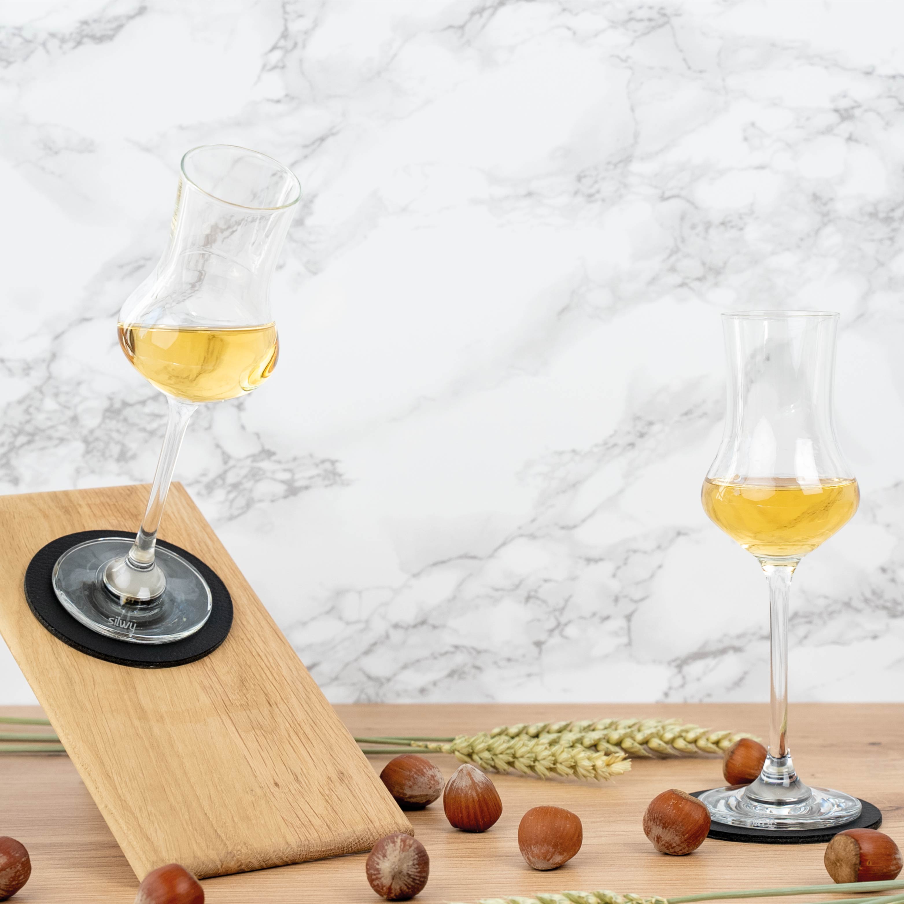 Crystal glasses of liqueur with magnet placed on pad (inclined position)
