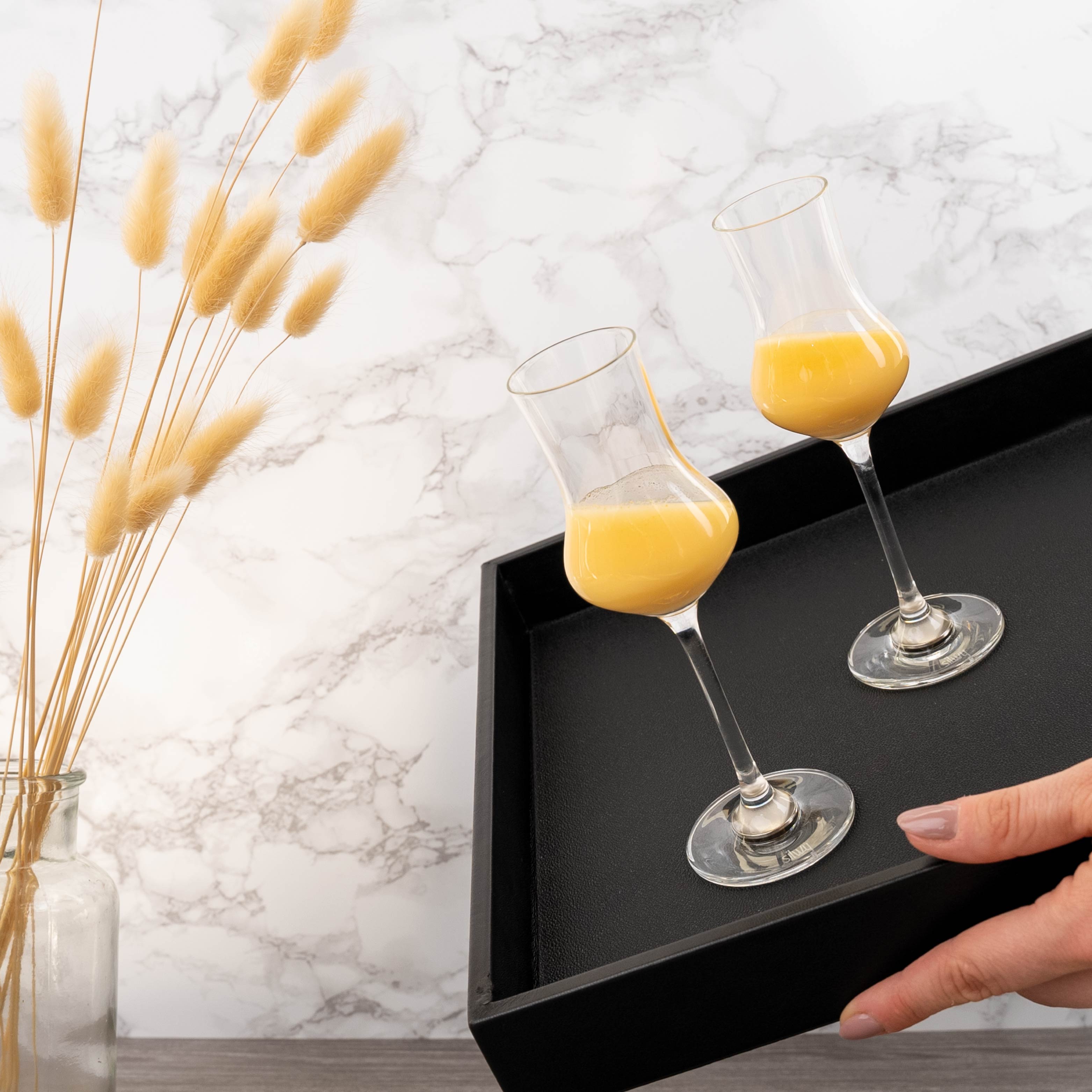 Magnetic crystal glasses liqueur on the metal tray in inclined position