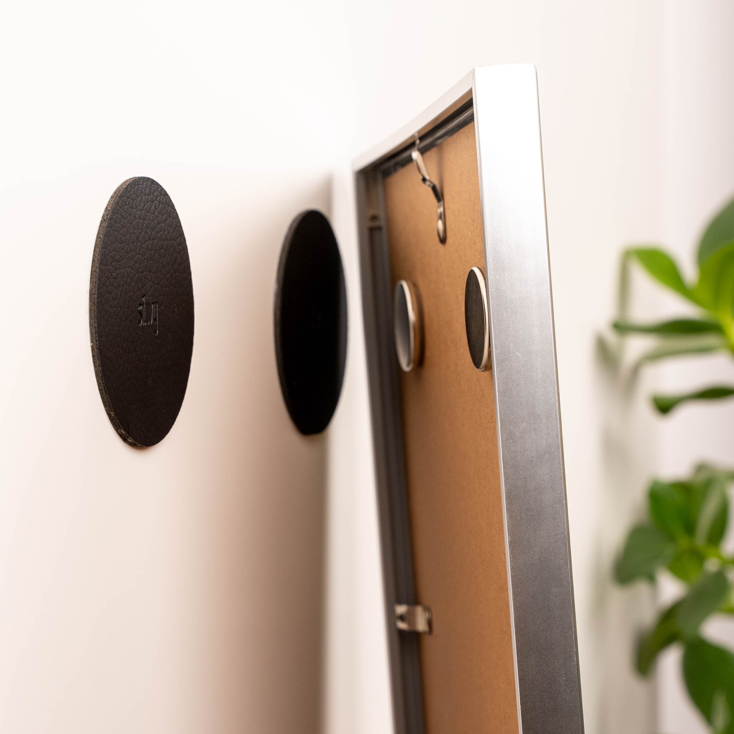 Picture frame with magnets is attached with pads