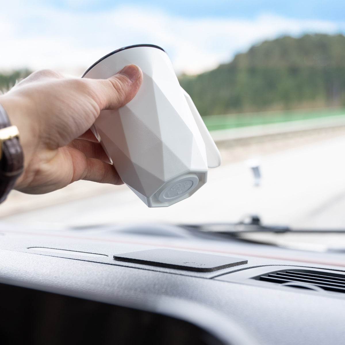 Close-up of integrated magnet in plastic cup on dashboard