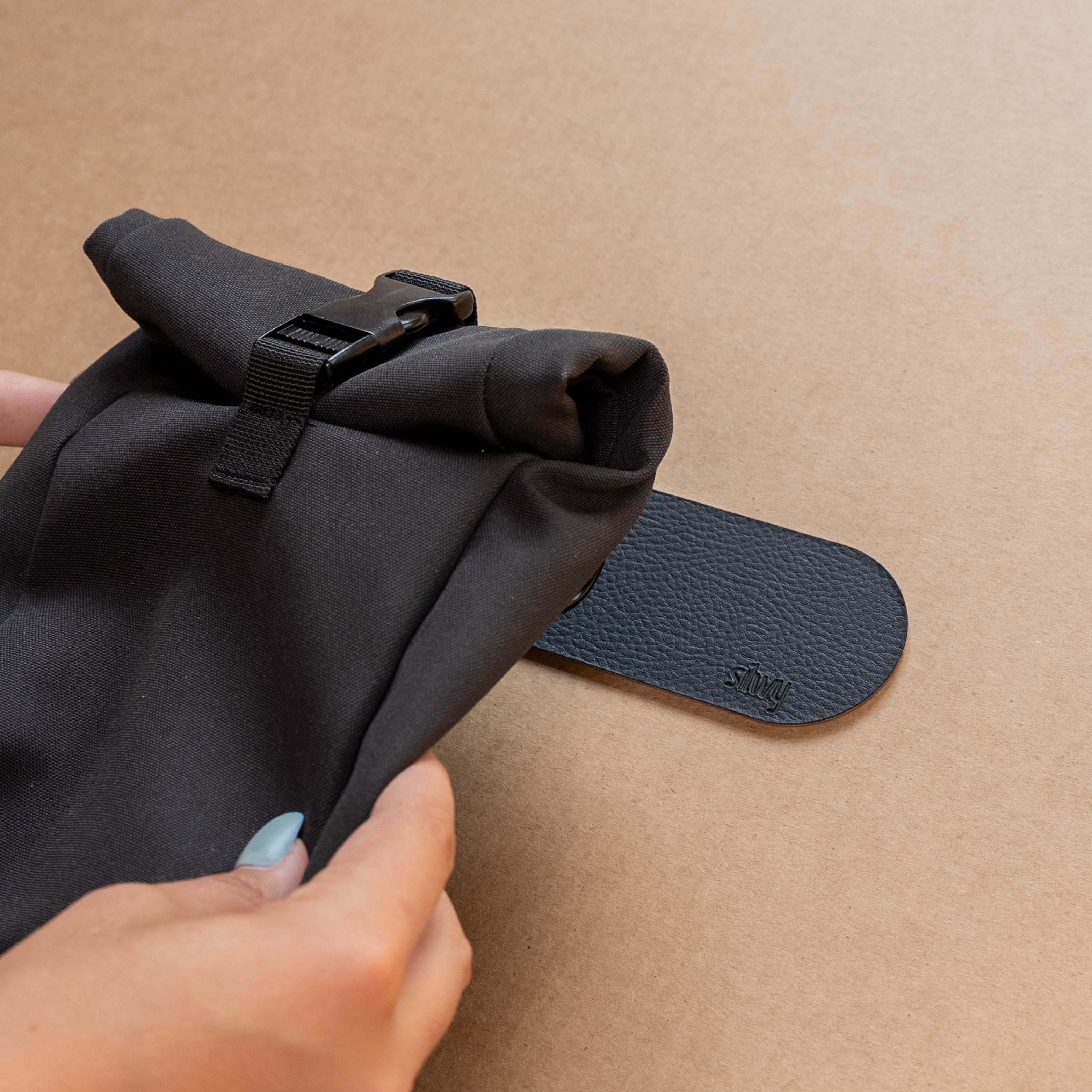 Magnetic bag is held in place by a metal strip
