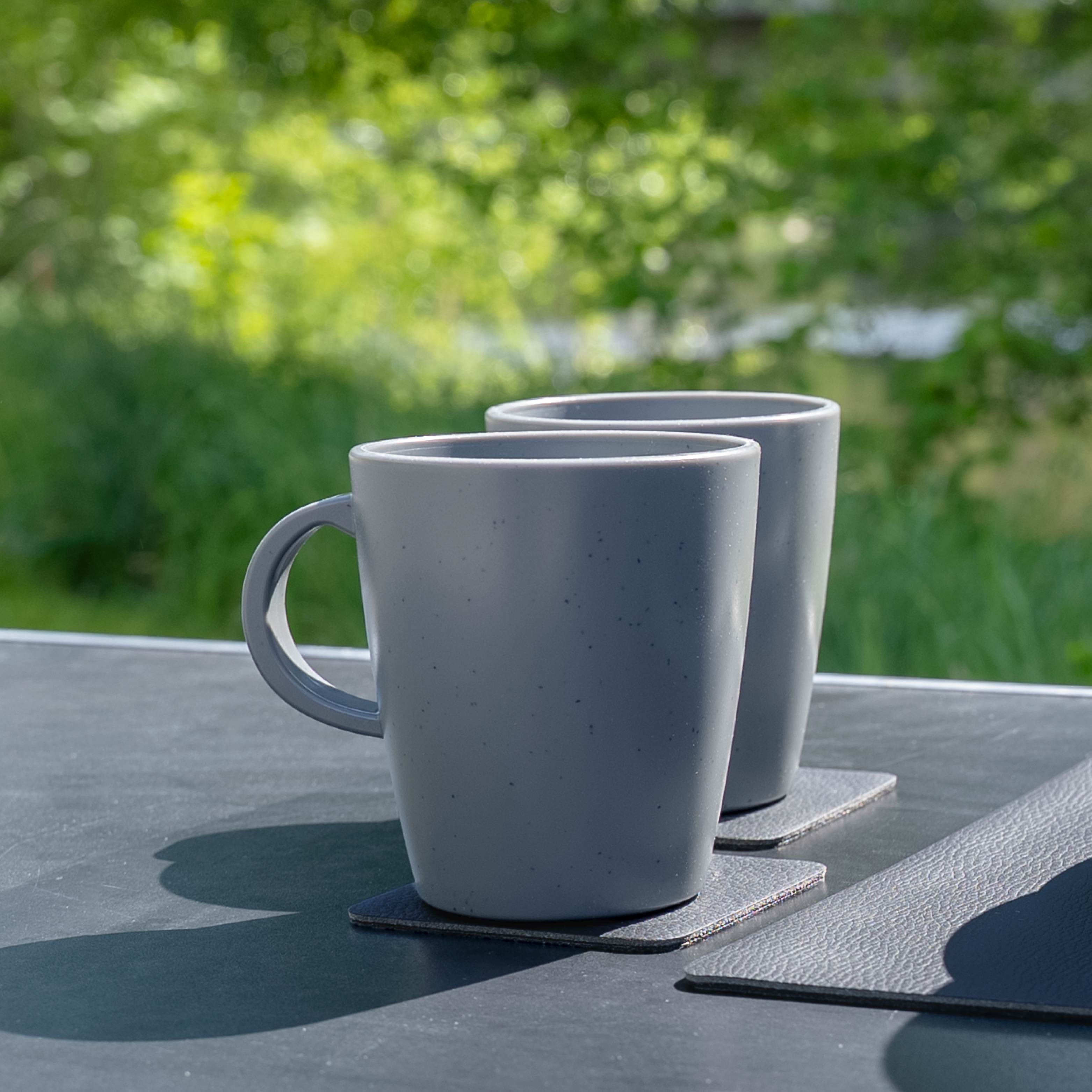 Magnetic plastic cups grey on camping table