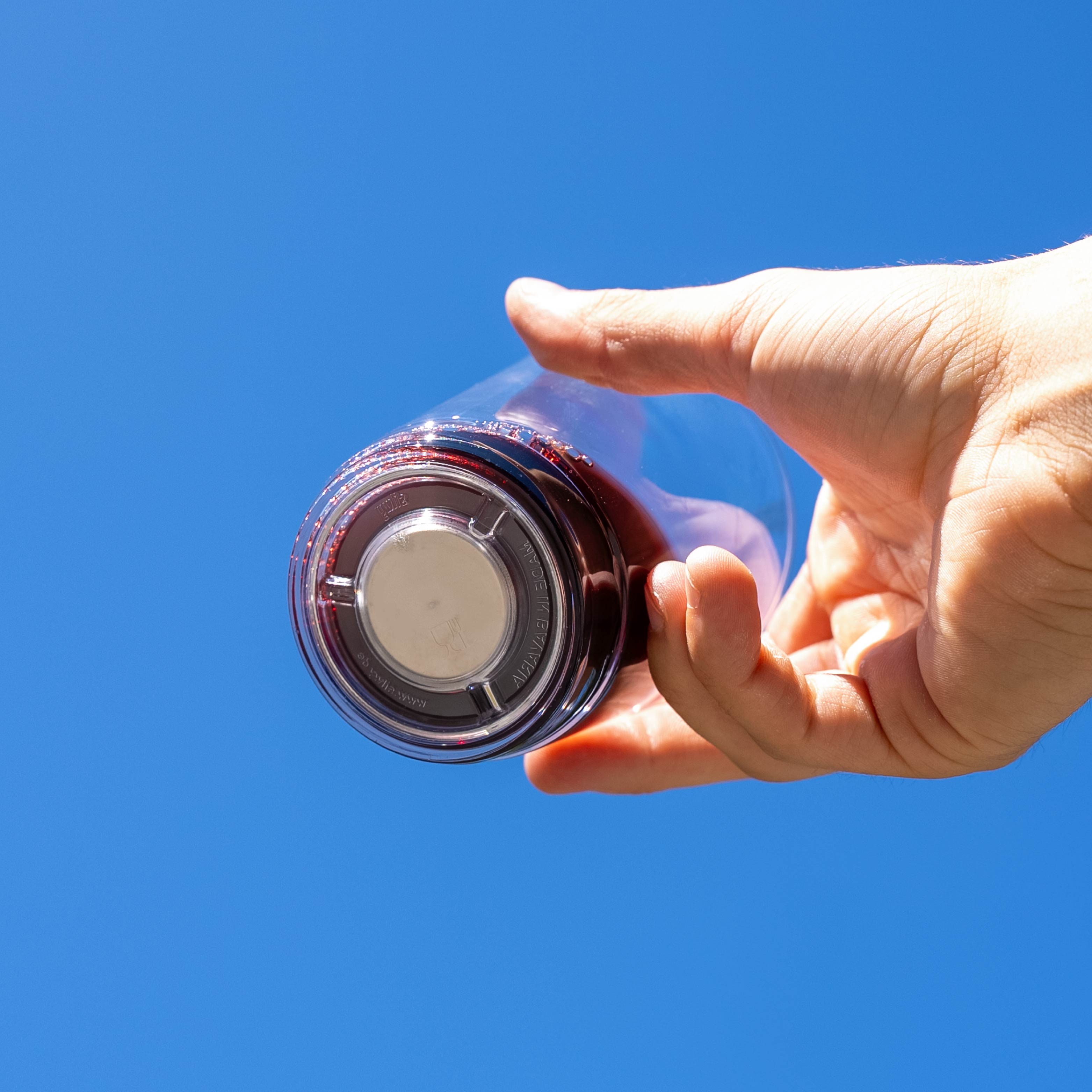 Filled magnetic jar with integrated magnet in the base against a blue background