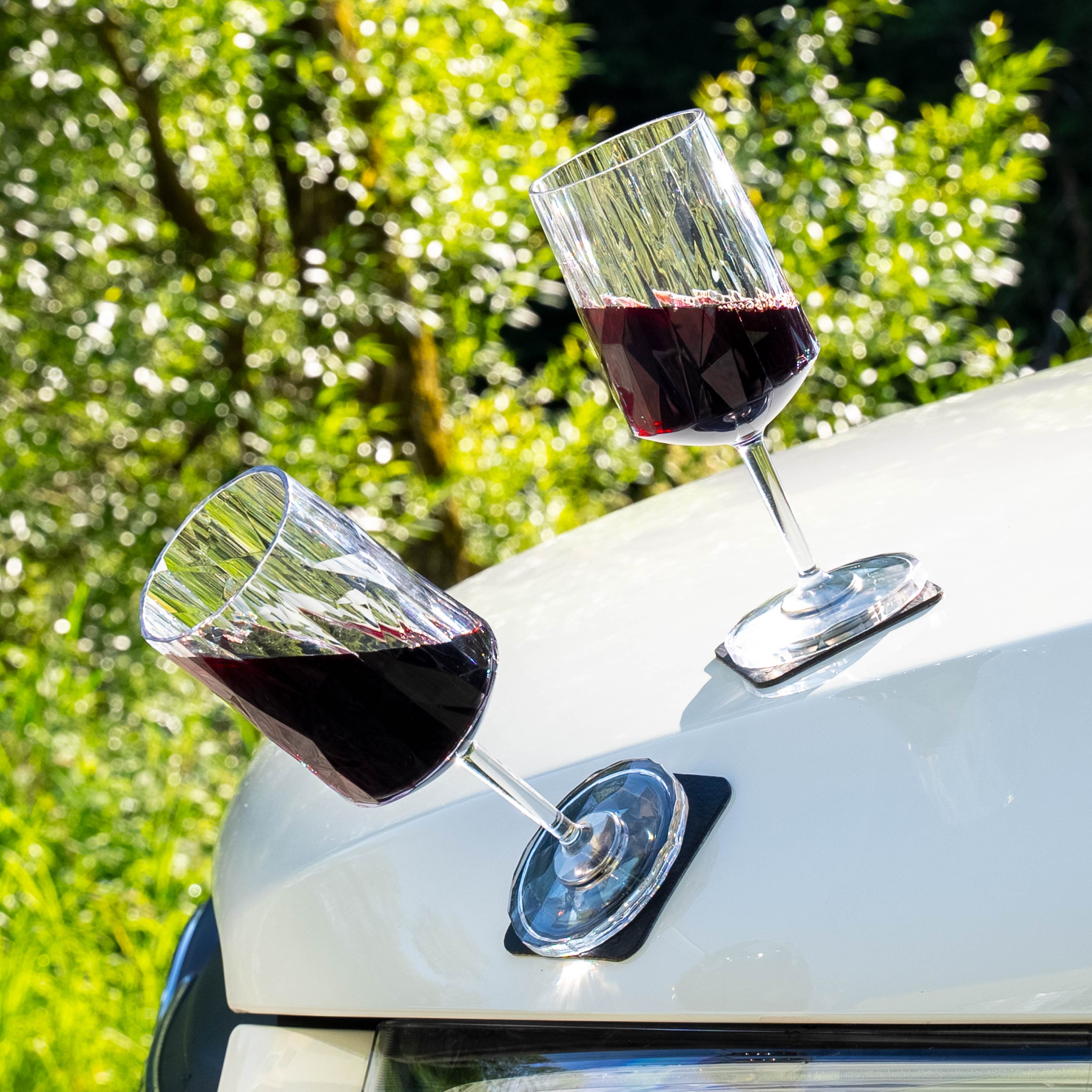 Magnetic plastic glasses wine placed on a metal hood