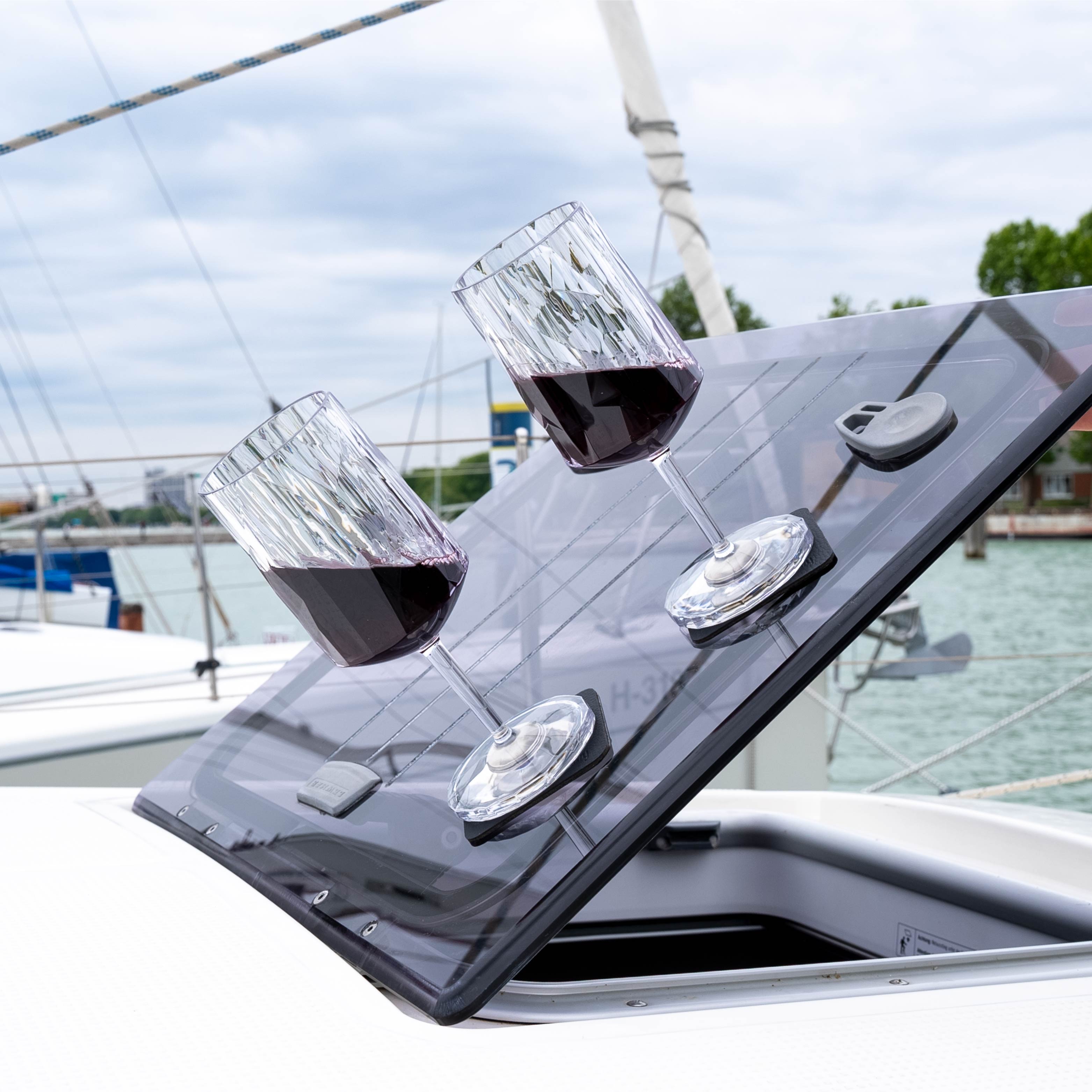 Magnetic plastic glasses wine placed on the pads in an inclined position on a boat