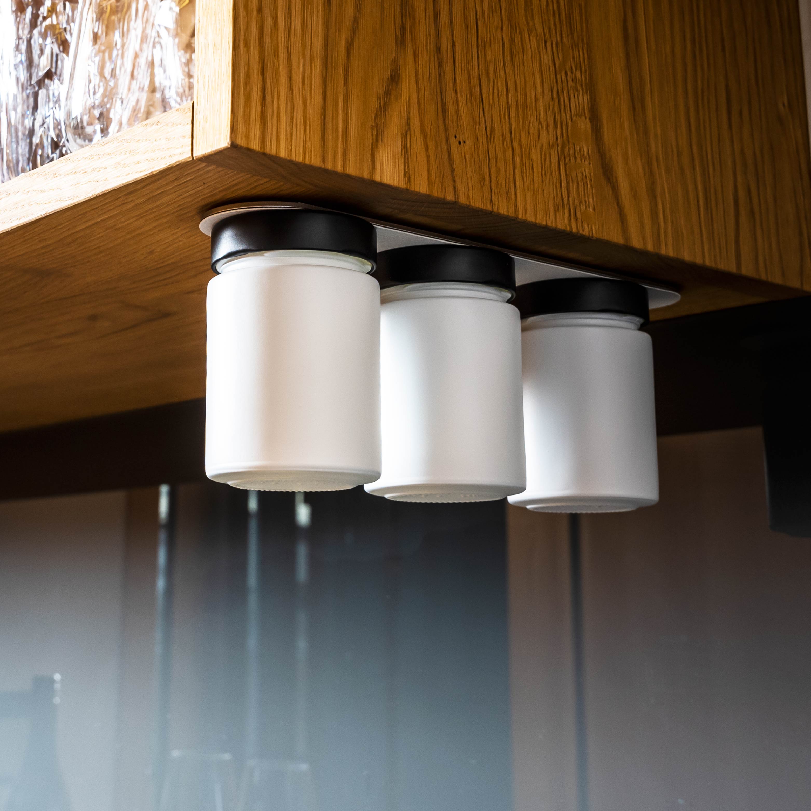 Magnetic deli jars mounted on metal strip in kitchen environment