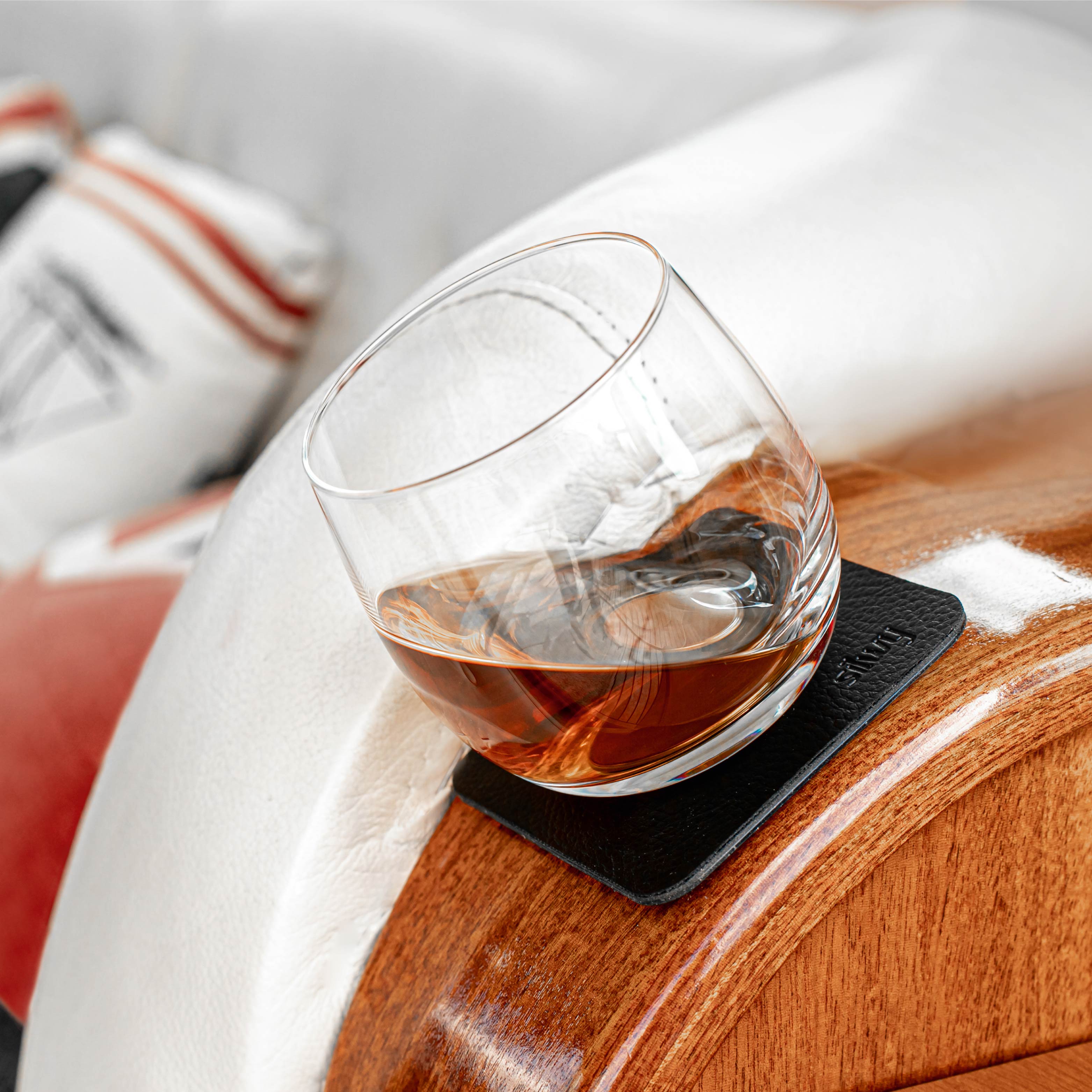 Bicchiere di cristallo magnetico per whisky su un cuscinetto in posizione inclinata su una barca
