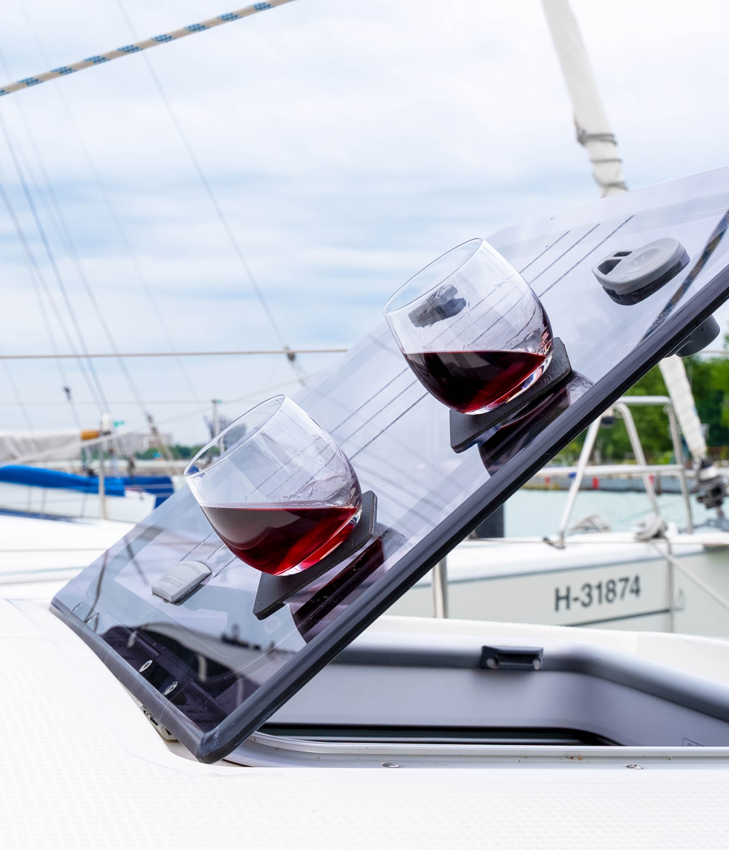 Magnetic whisky glasses made of crystal glass fixed with pads, on a boat