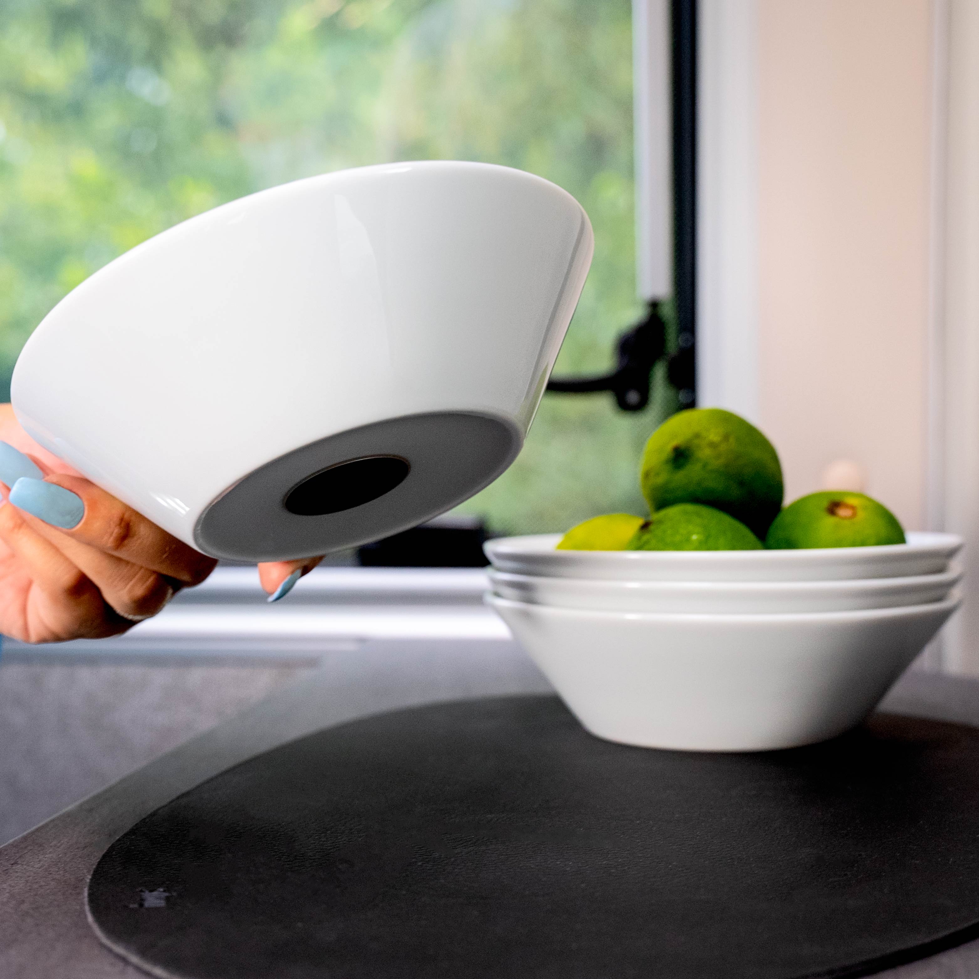 Magnetic porcelain bowl with integrated magnet in the base stacked on top of each other on a metal mat 