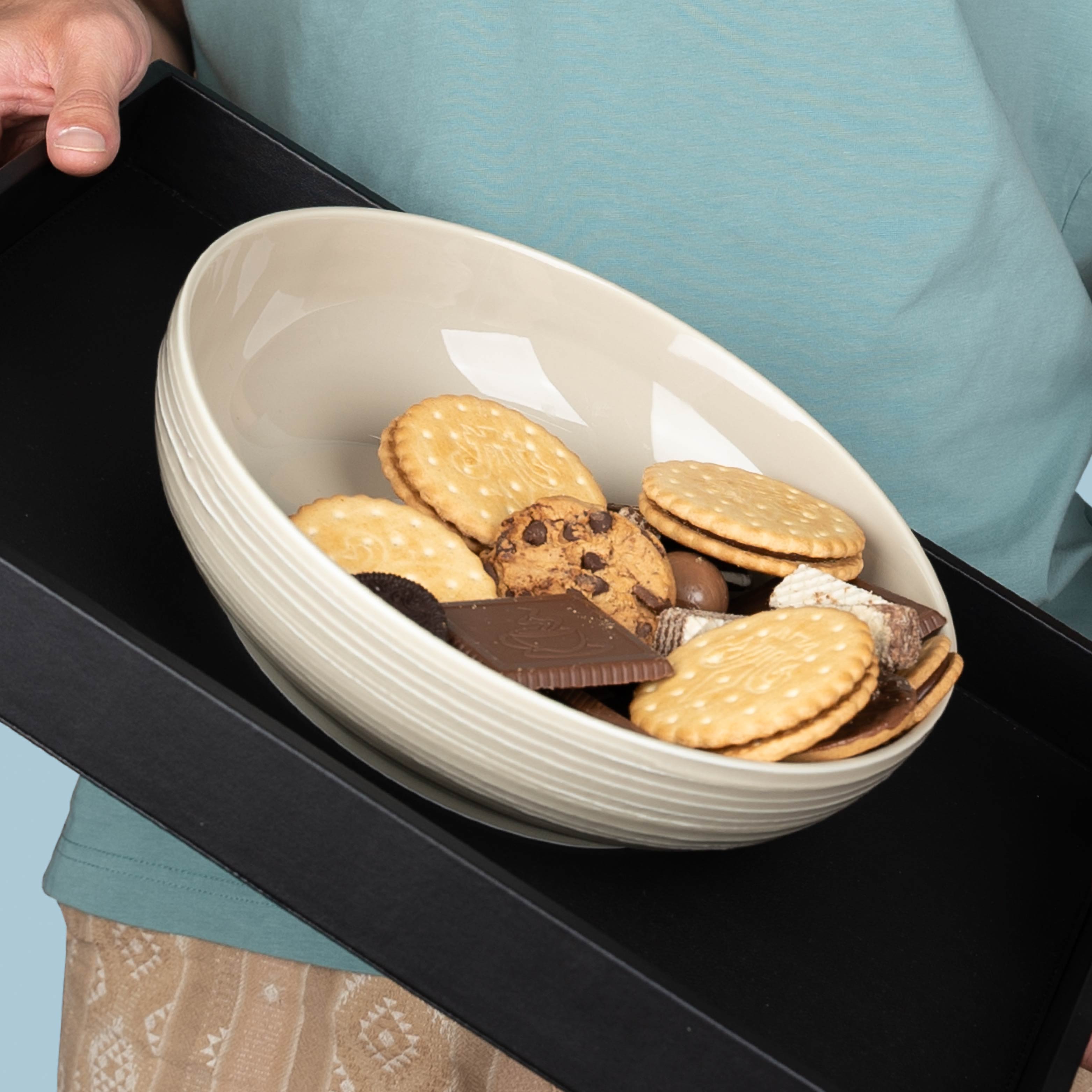 Bowls  porcelain bowls ofSand filled with cookies on a metal tray 