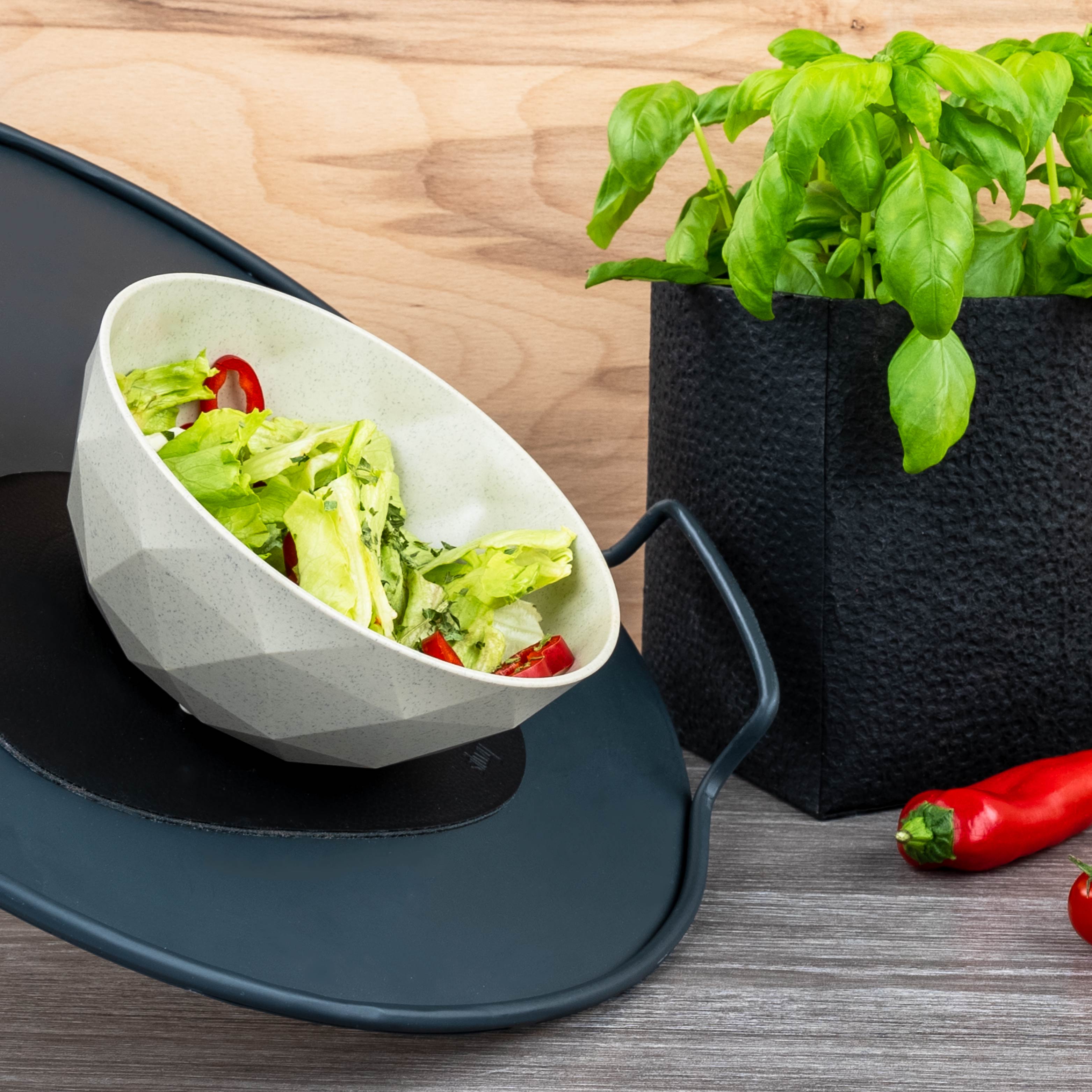 Magnetic bowl is fixed in an inclined position by a metal placemat