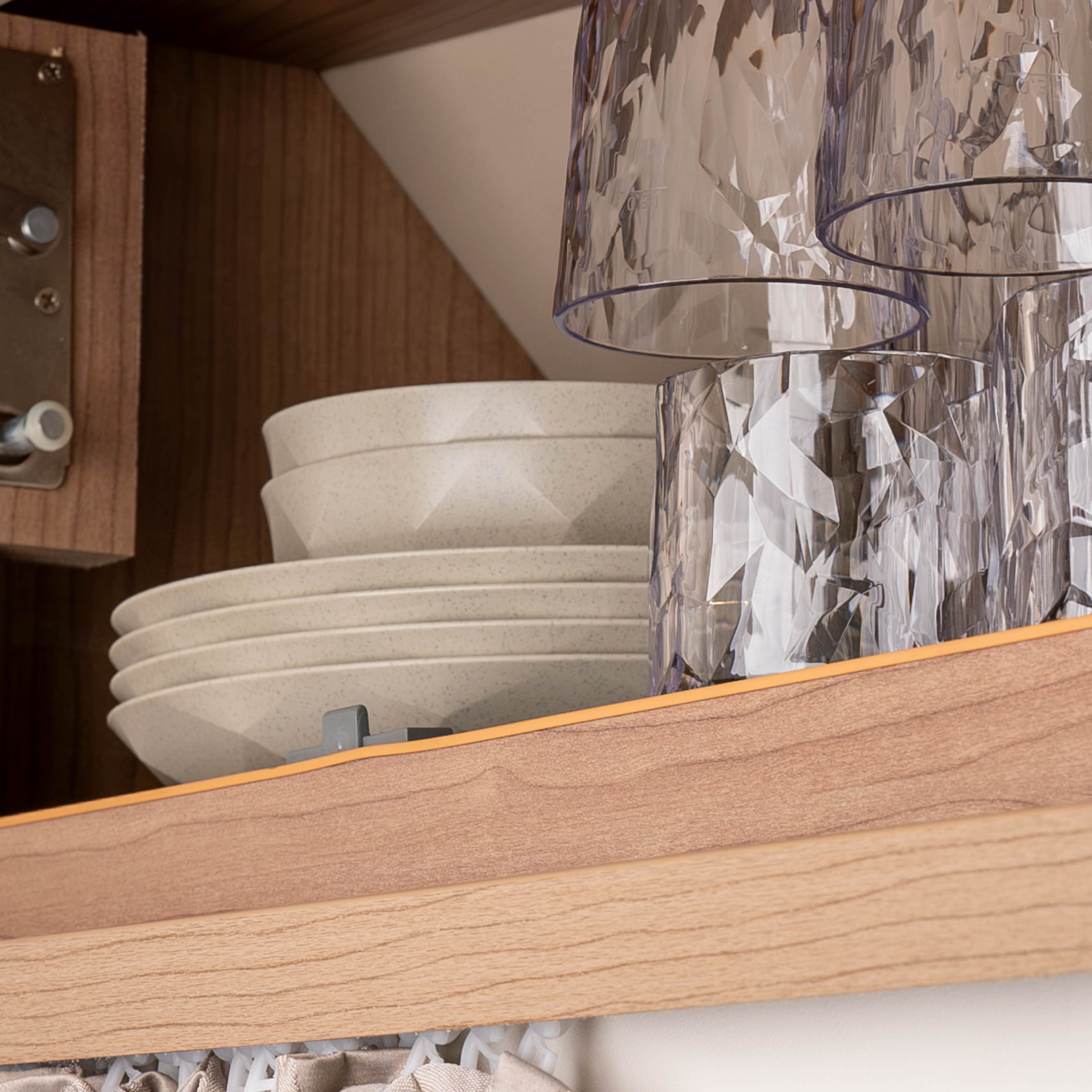Magnetic plastic crockery stacked in the cupboard to save space 