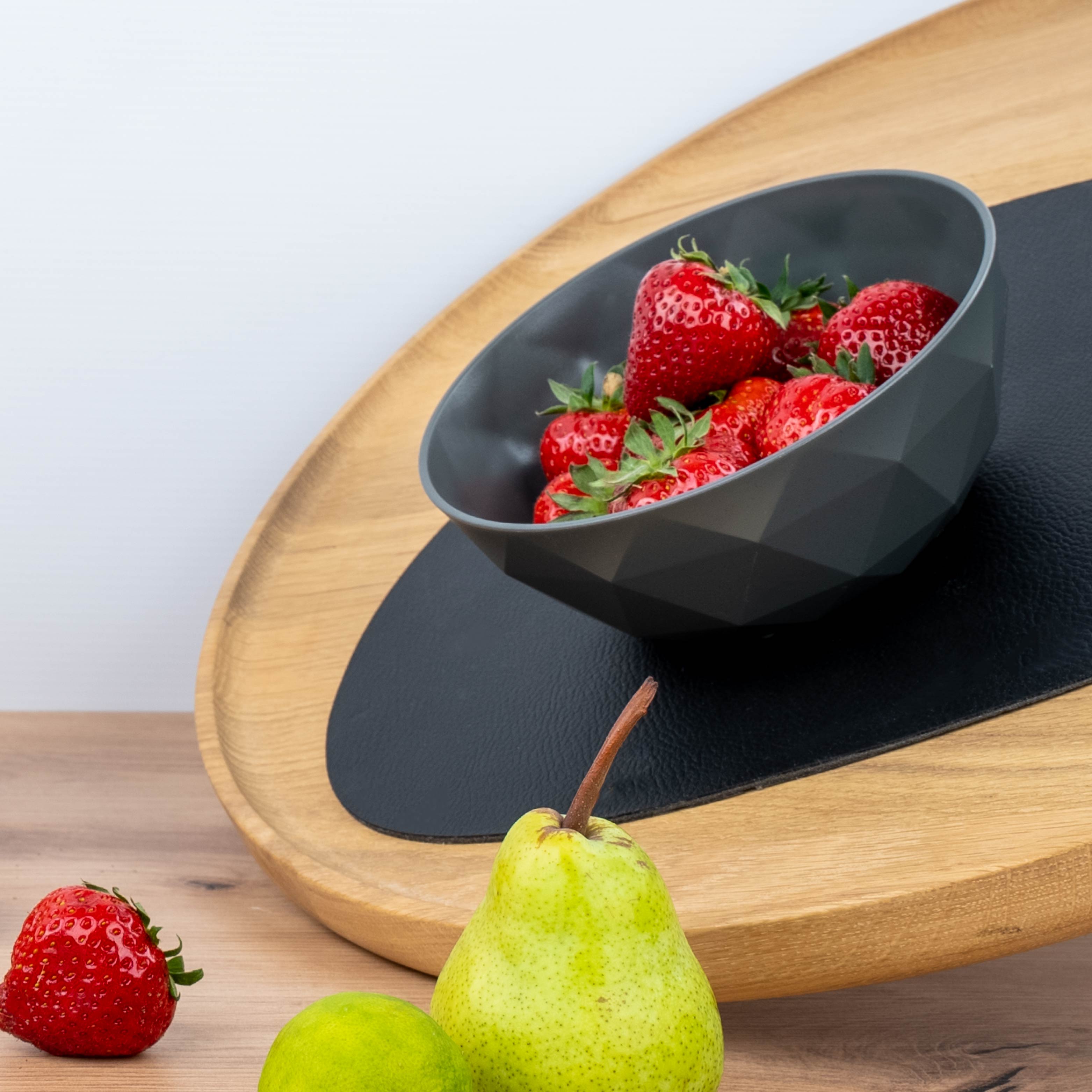 Magnetic plastic bowl placed on placemat in inclined position
