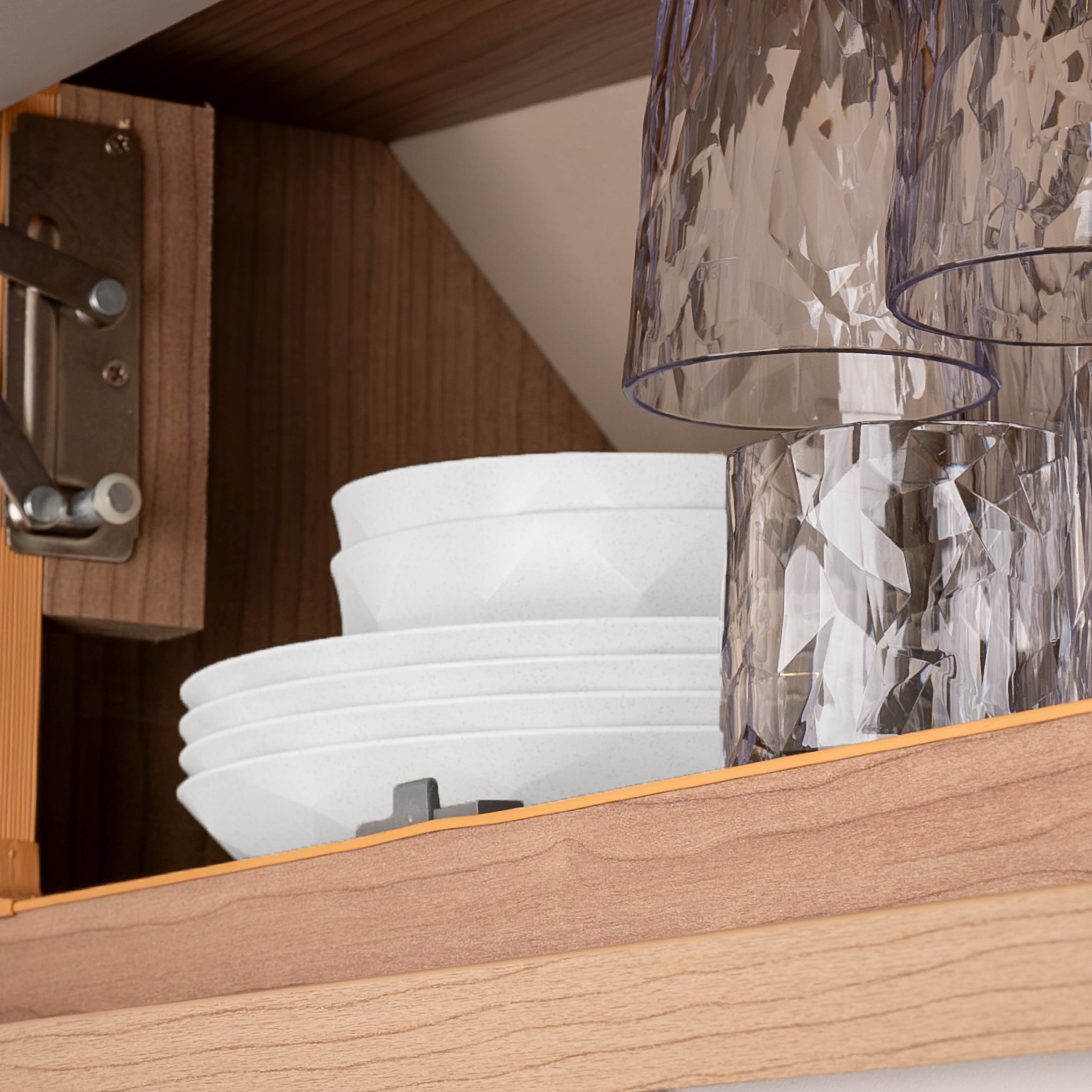 Plastic glasses hanging upside down on the Metal Strip with magnet in a camper van cupboard