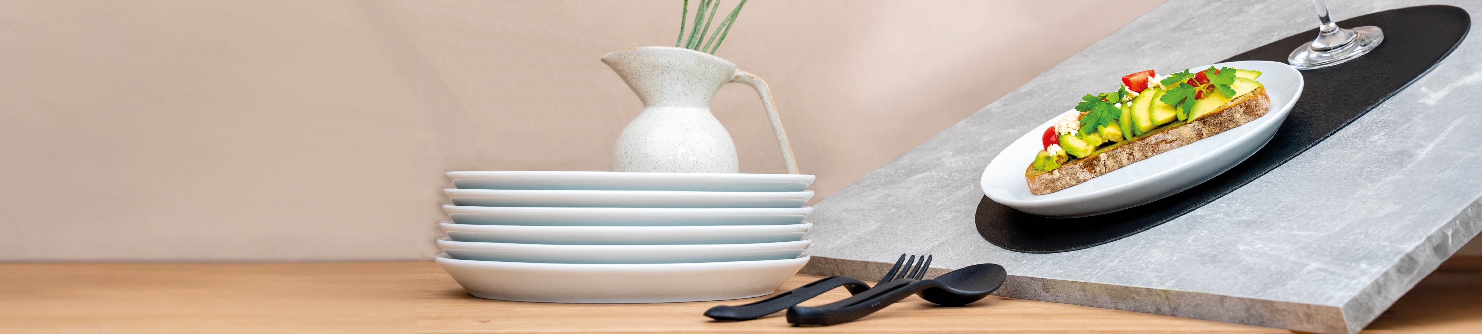 Plates porcelain plates stacked and slanted on placemat 