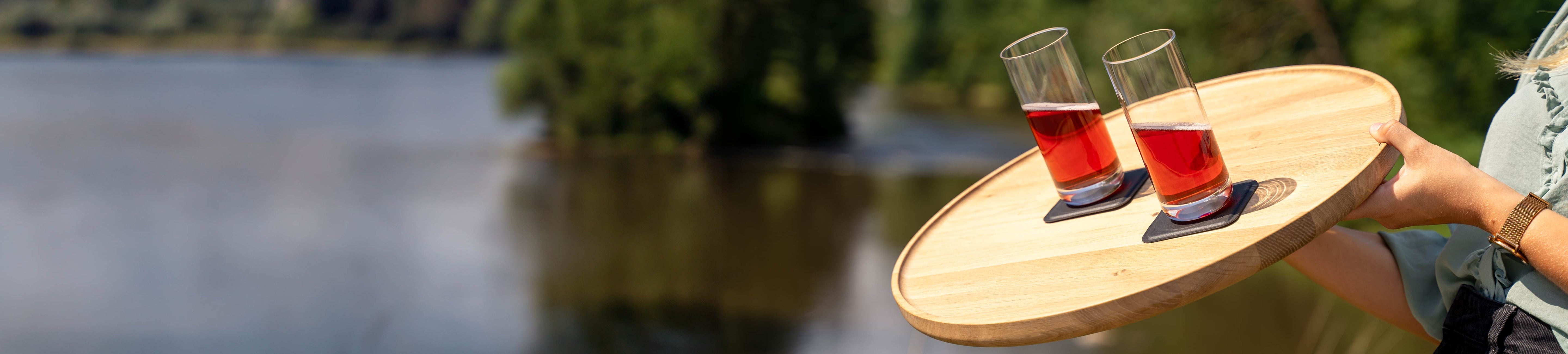 Magnetic crystal glasses longdrink slim placed on pads, which are placed on a wooden tray in an inclined position