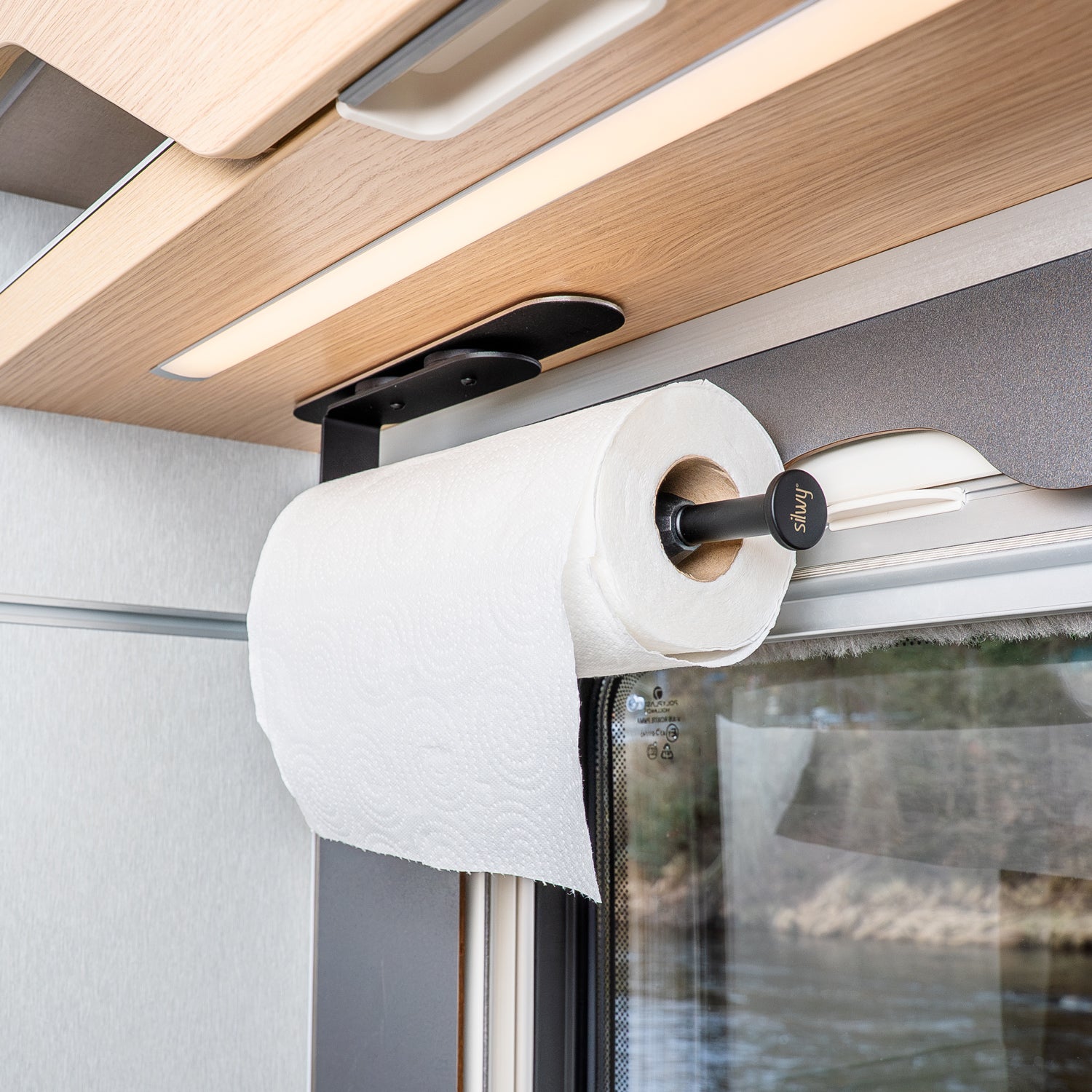 Kitchen roll holder mounted on bar in the camper