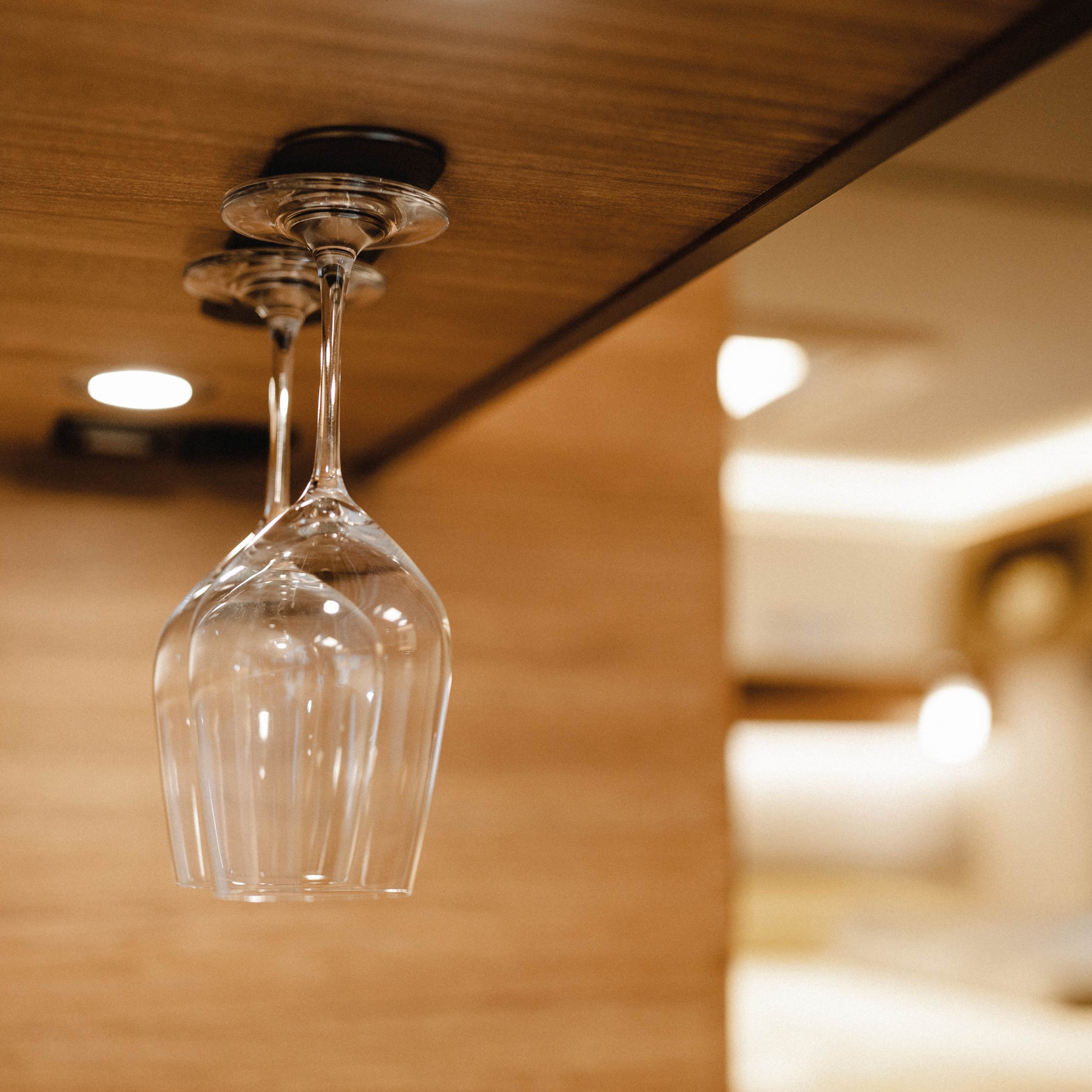wine glasses on overhead rail
