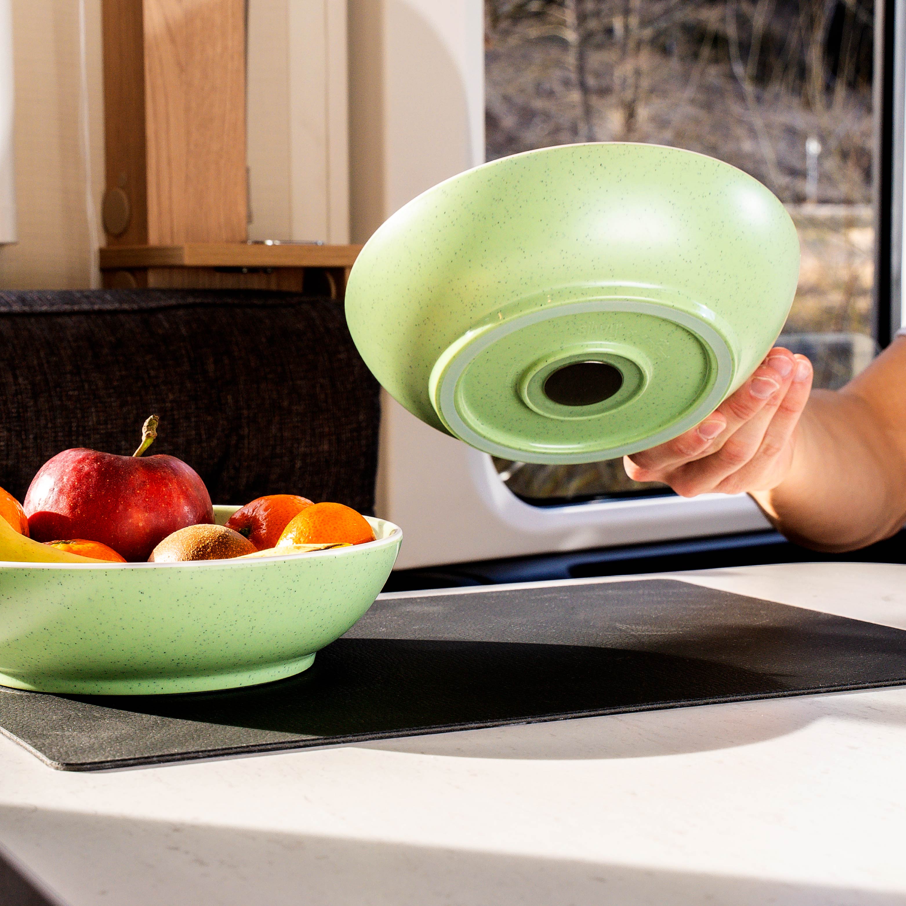 Food bowl in green is placed on the metal-nano-gel-mat