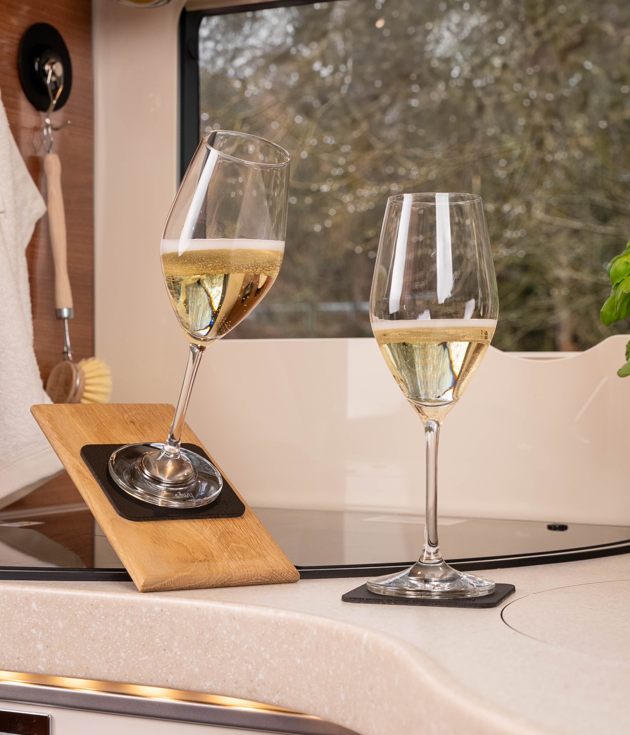 Magnetic crystal champagne glasses standing on pads in the camper