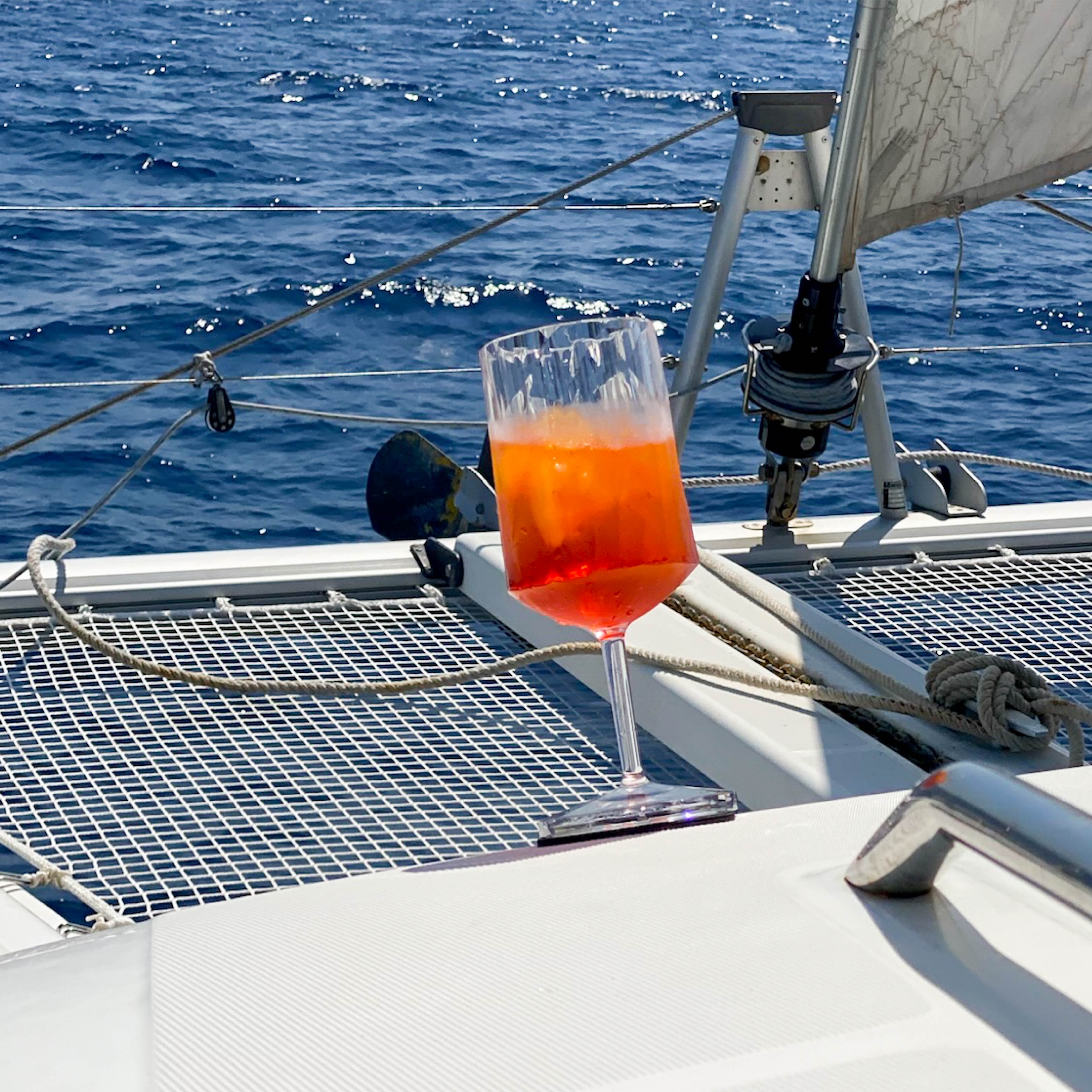 Filled Magnetic plastic glass wine on a pad in an inclined position on a boat