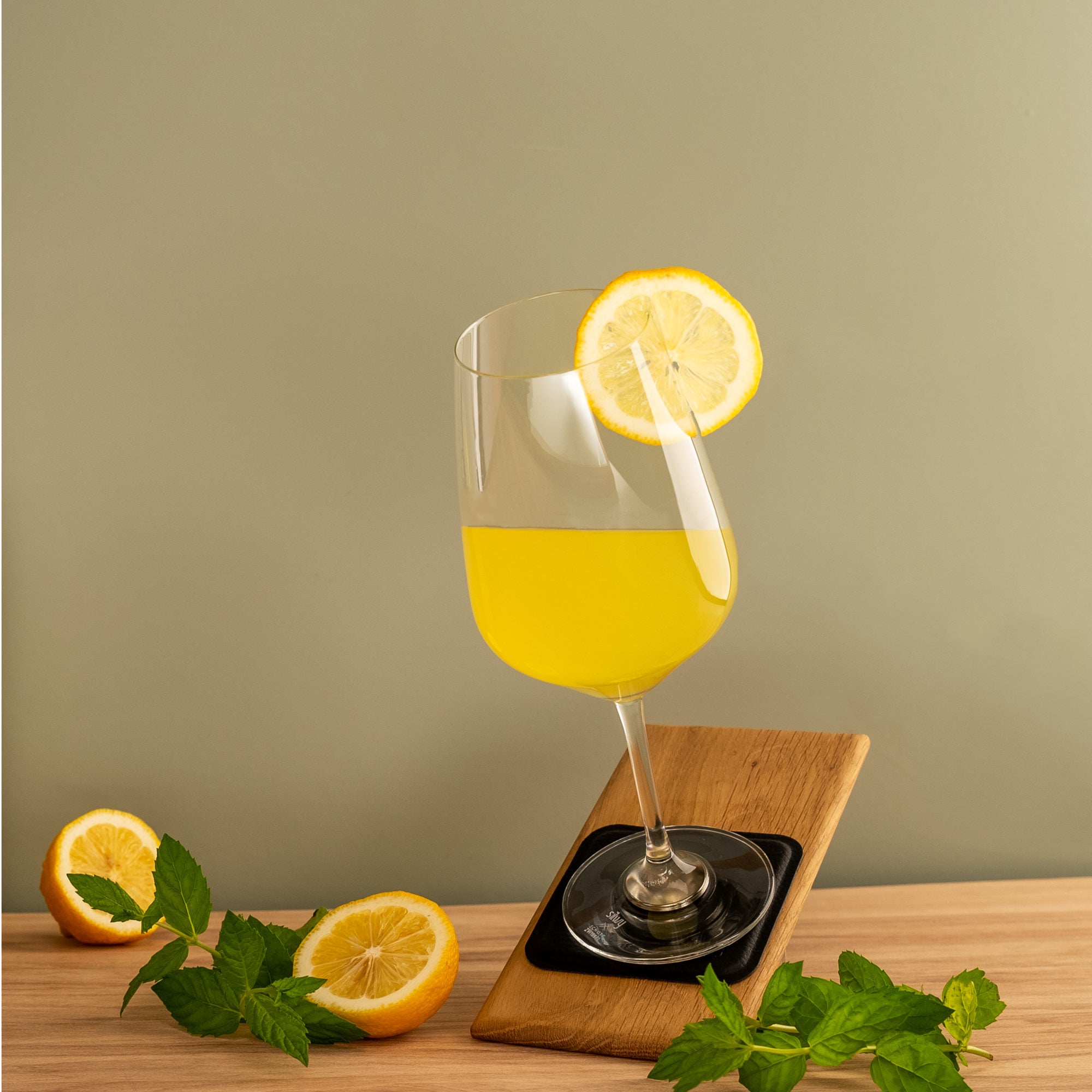 Filled crystal glass WINE BORDEAUX, stands at an angle on metal-nano-gel-pad
