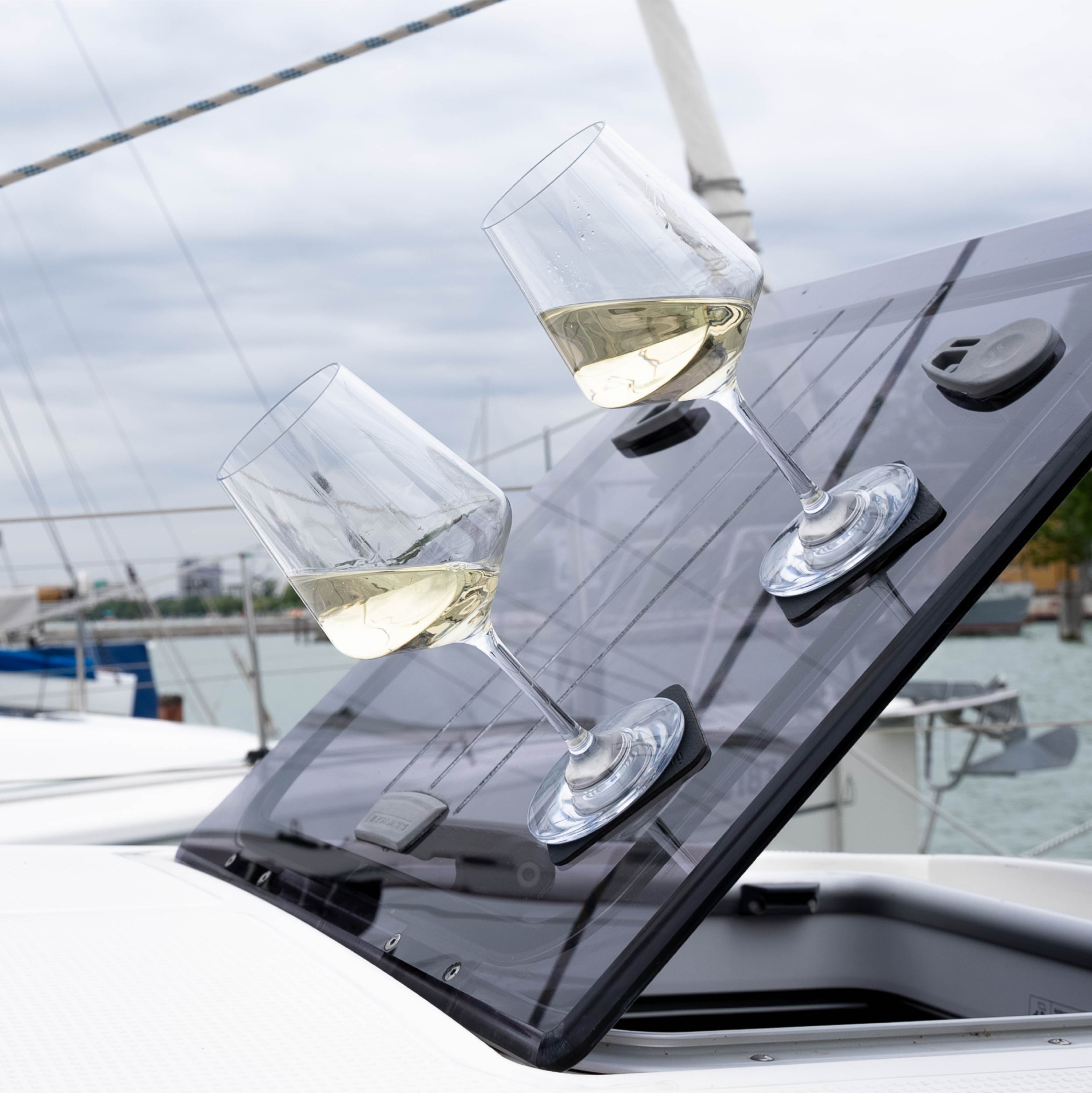 Magnetic plastic glasses wine on pads in an inclined position on a boat