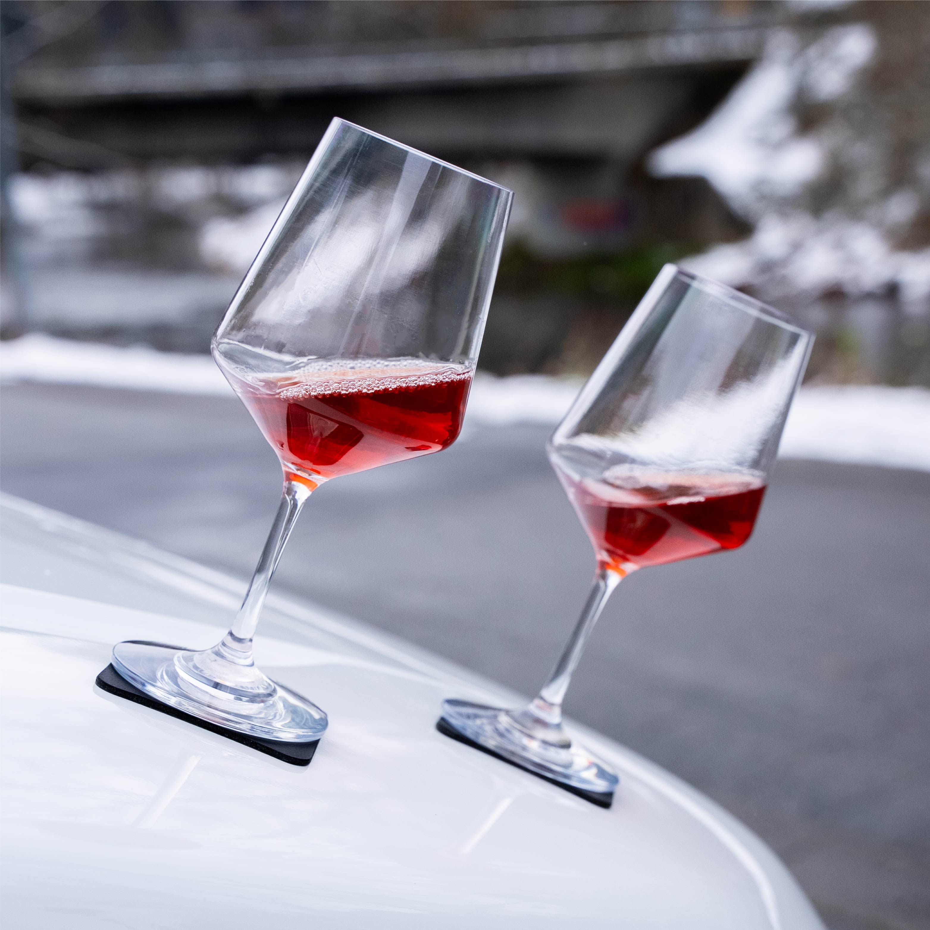 Magnetic plastic glasses wine placed on a metal hood