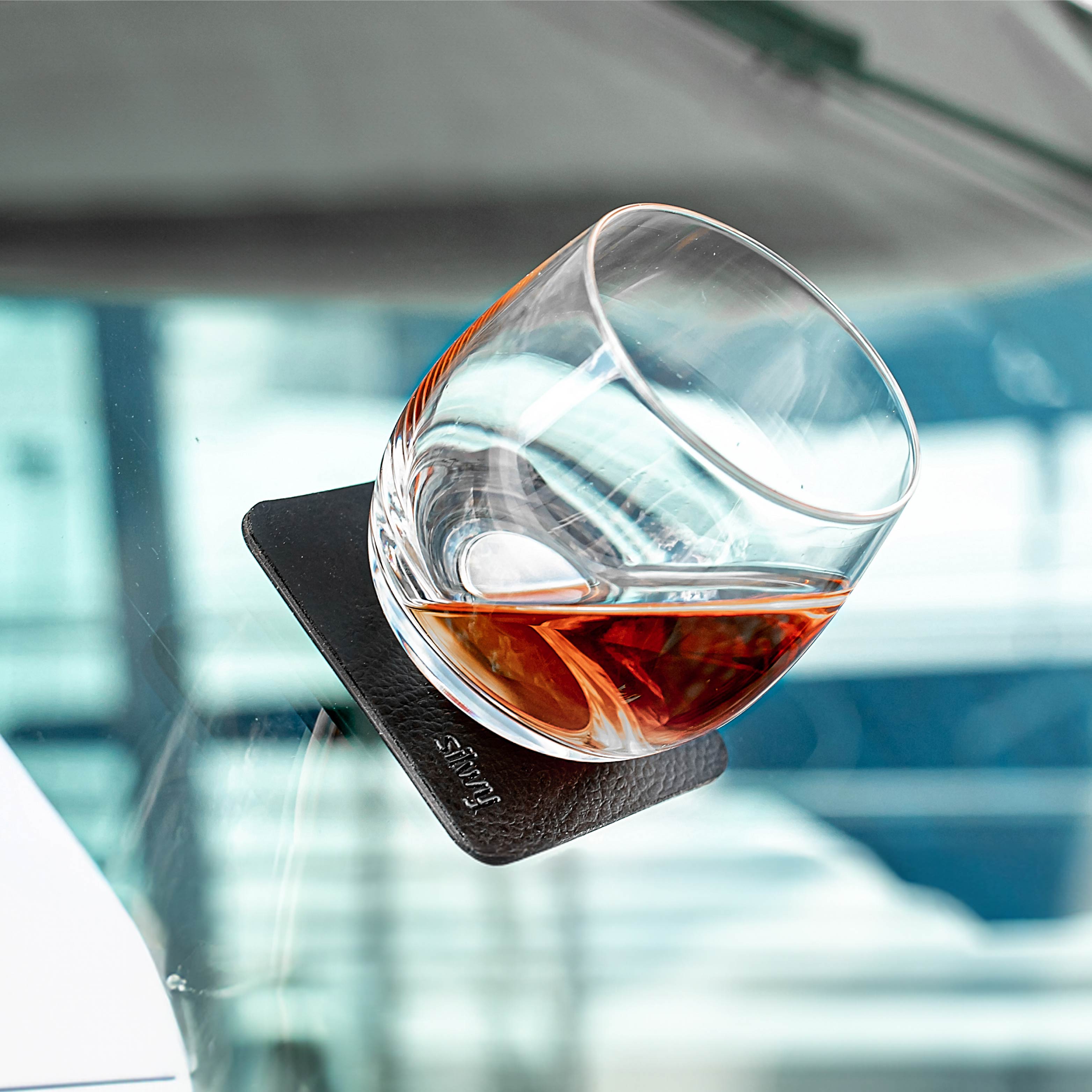Magnetic crystal glass whisky on a pad in an inclined position on a boat