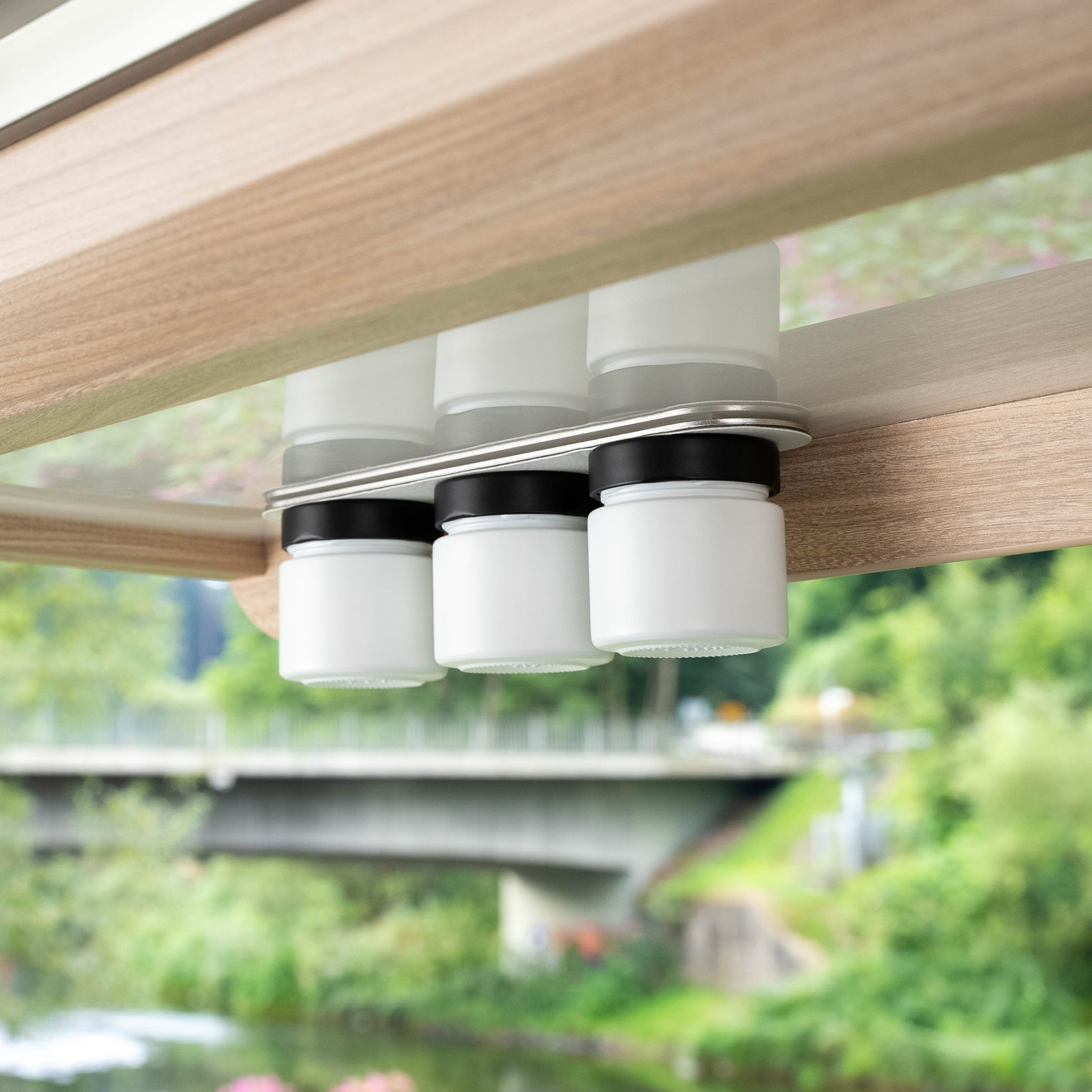 Magnetic delicatessen jars hanging on a rail in the camper 