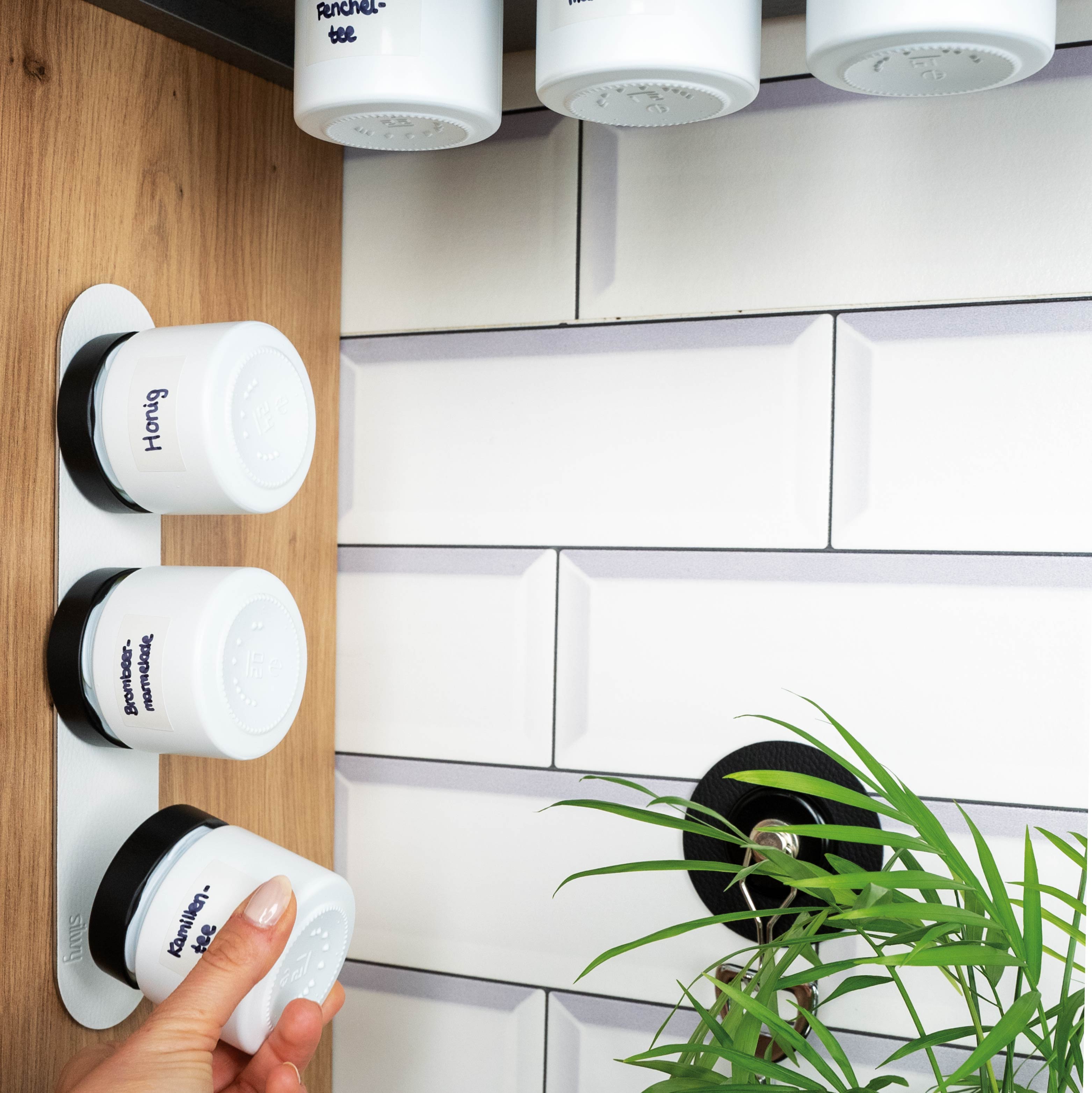 Magnetic deli jars mounted on Metal Strip in kitchen environment 