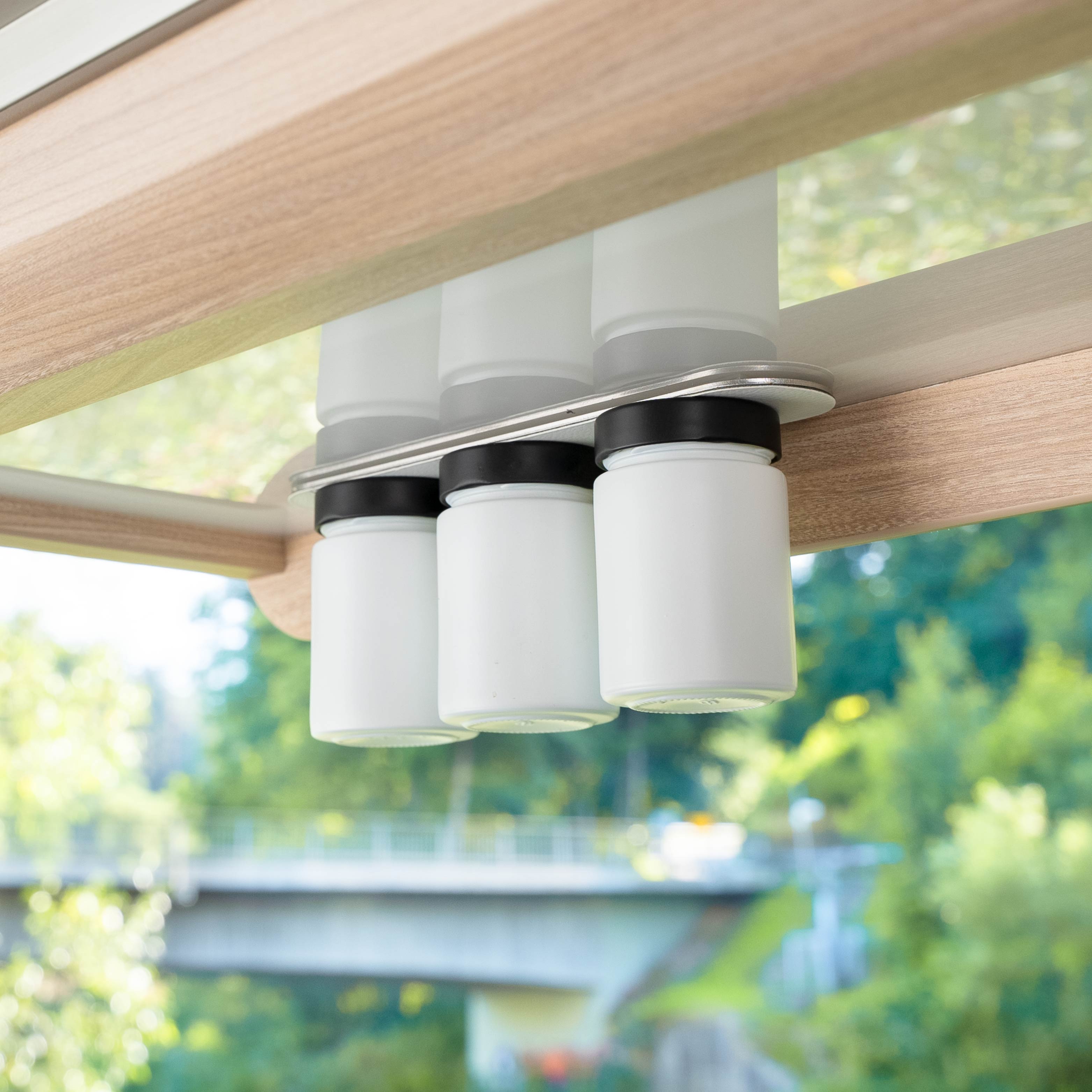 Magnetic deli jars placed on bar in the camper