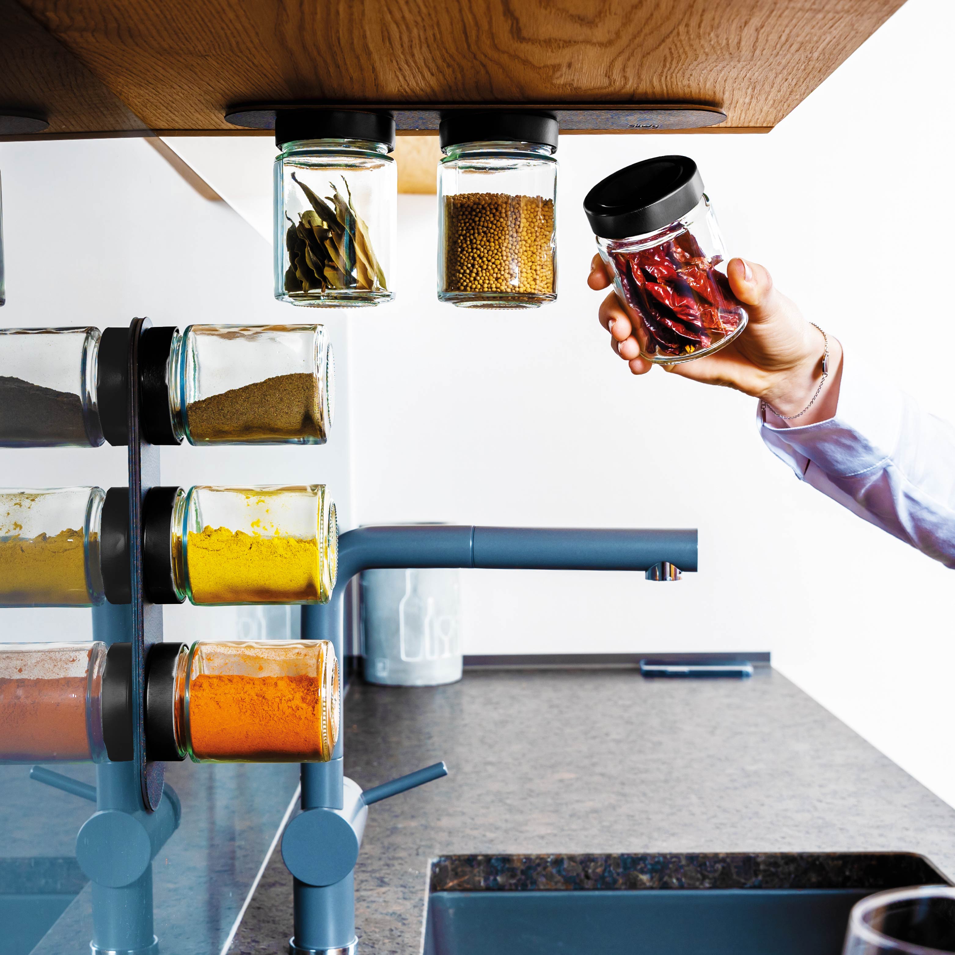 Magnetic deli jars mounted on Metal Strip in kitchen environment 
