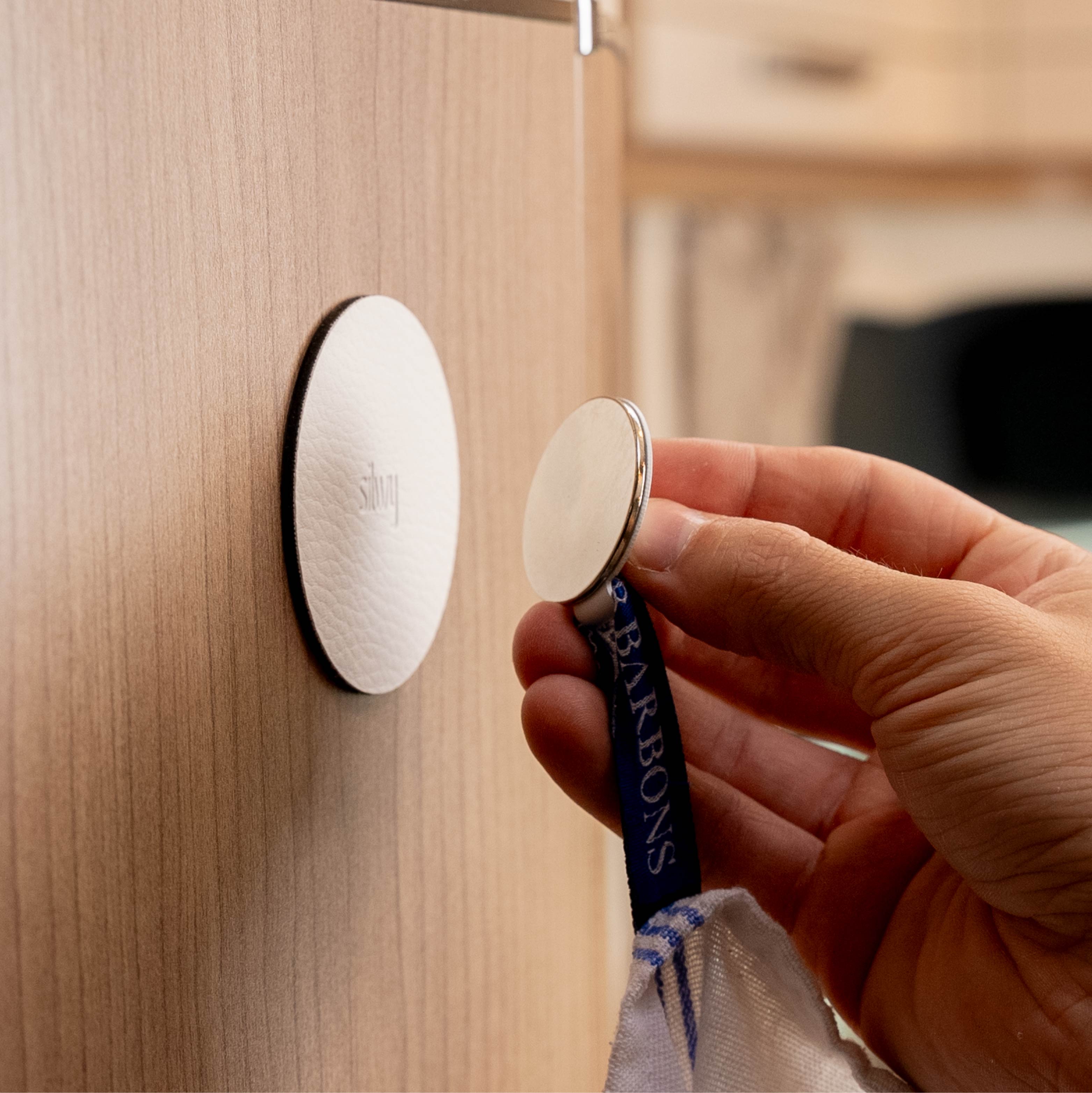 Magnetic hook is held in place by a metal pad