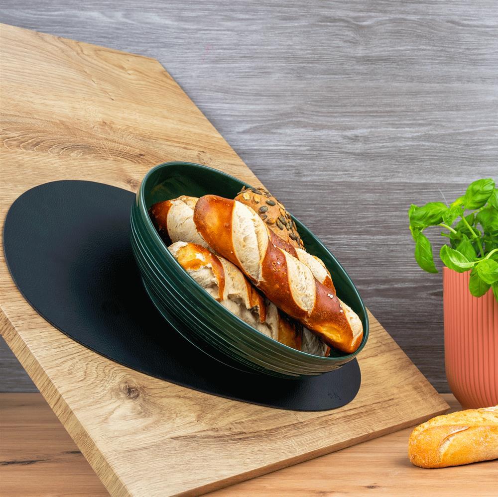 Food bowl on sloping surface standing on placemat