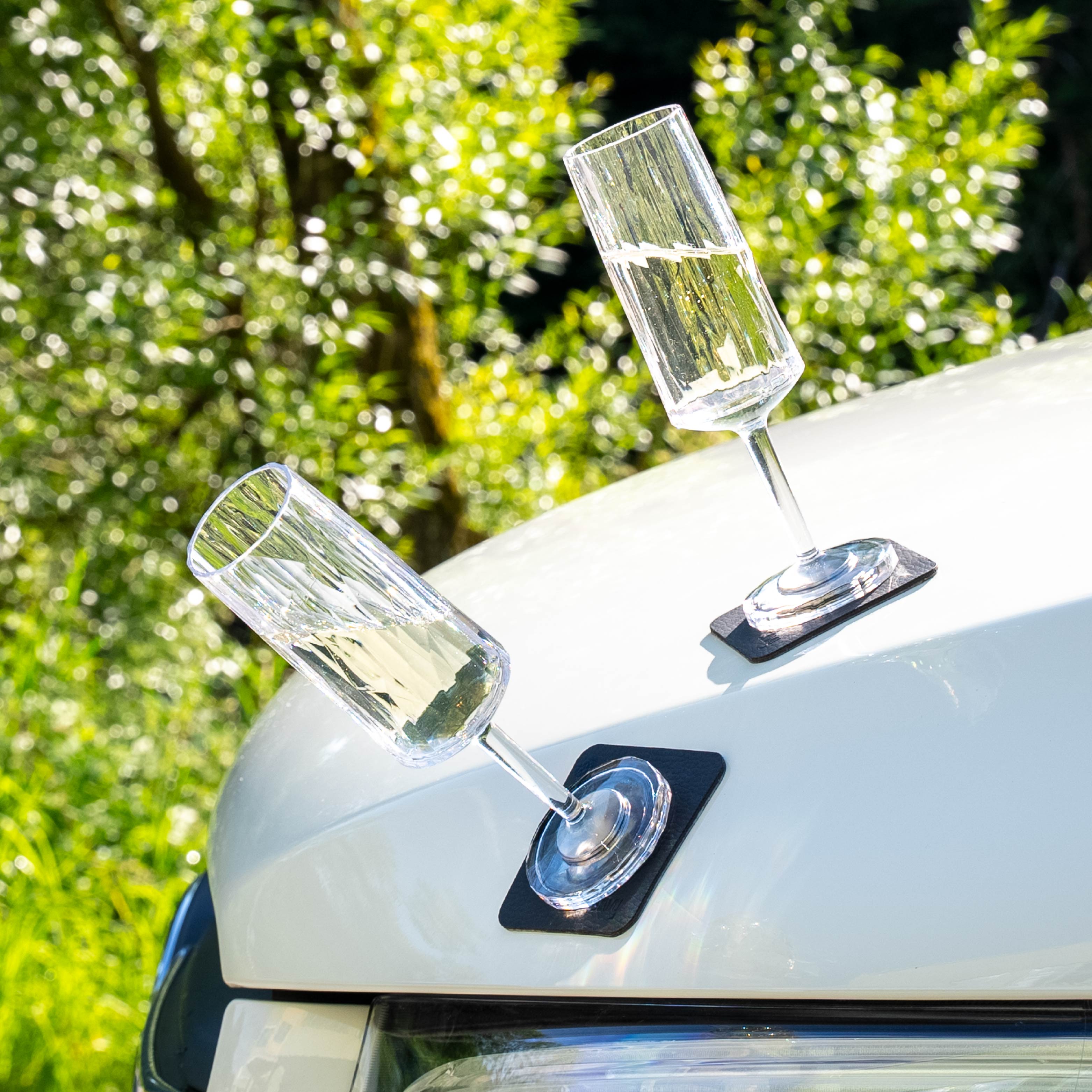 Magnetic plastic glasses champagne placed on a metal hood