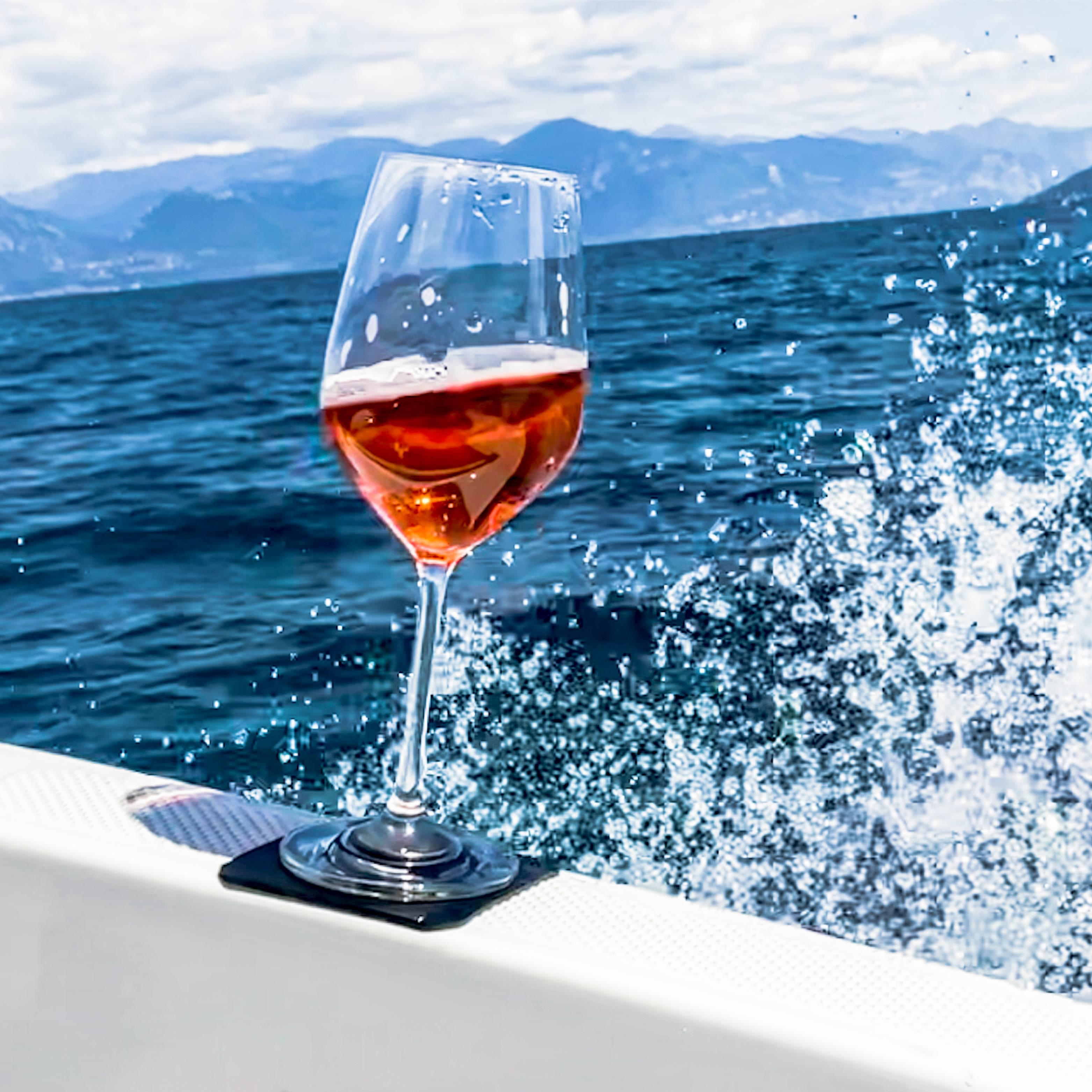 Magnetic crystal glass wine placed on pad, on a boat while driving