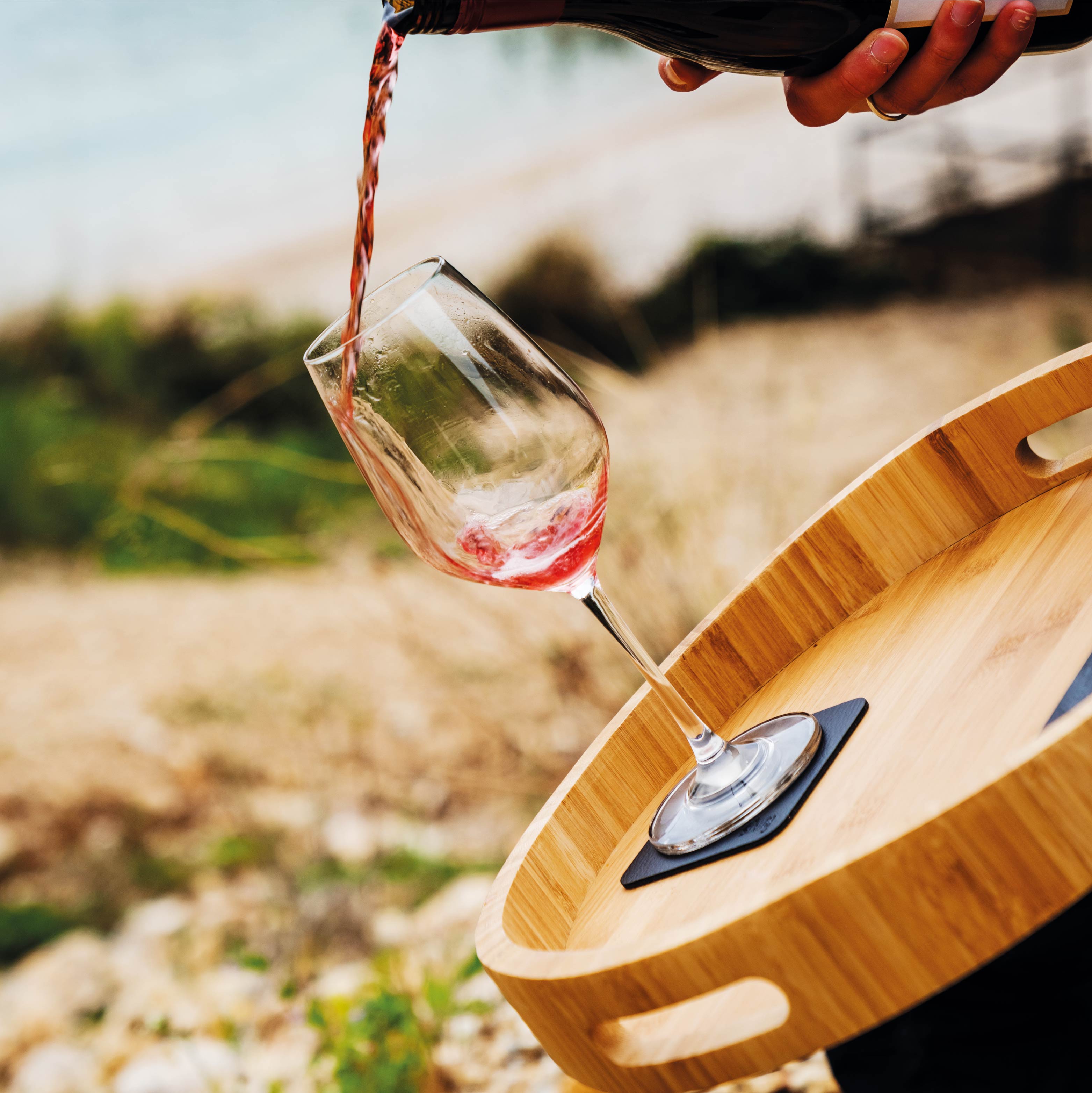 Magnetic crystal glass wine on pad while it is fixed on a tray in an inclined position