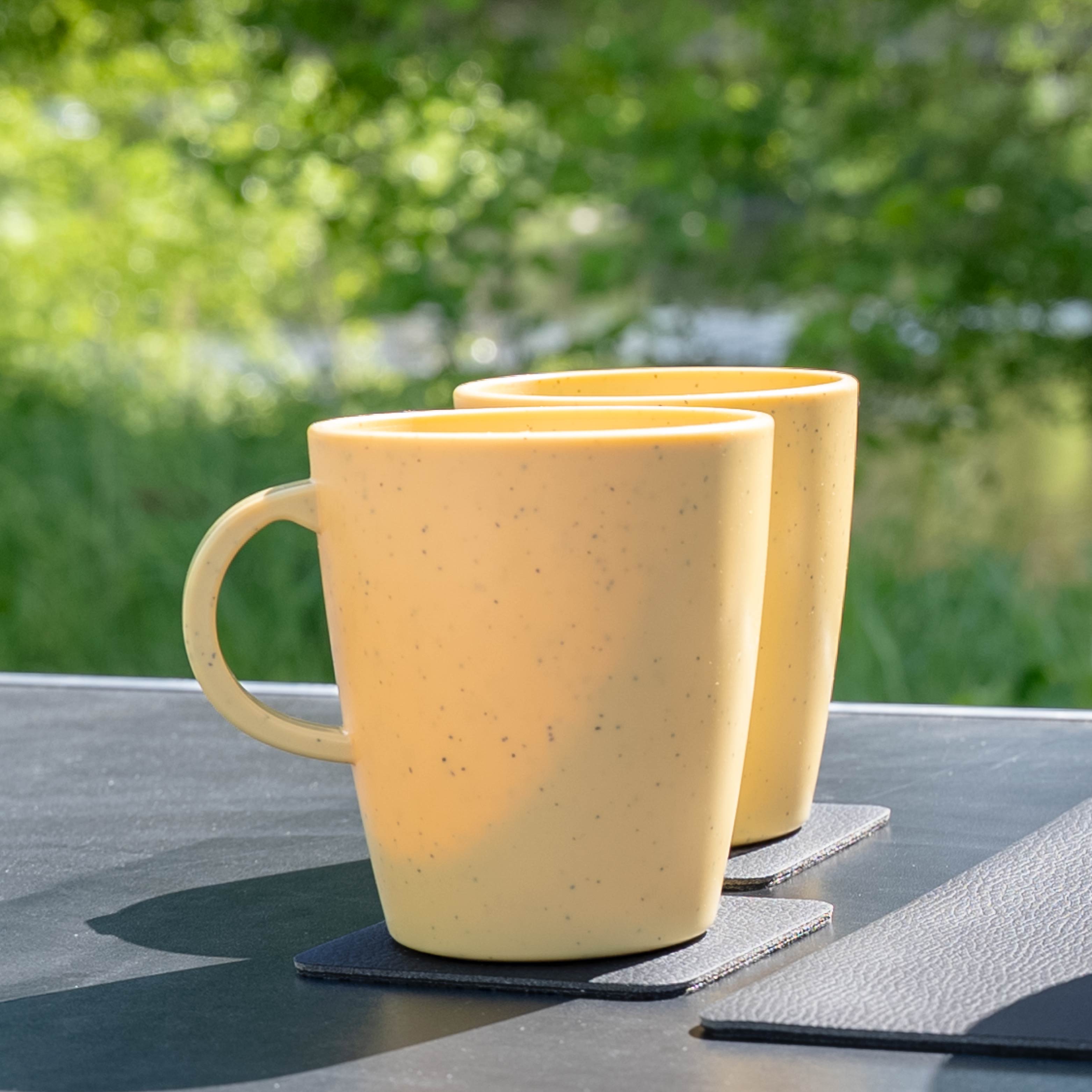 Tazas de plástica magnéticas yellow sobre mesa de camping