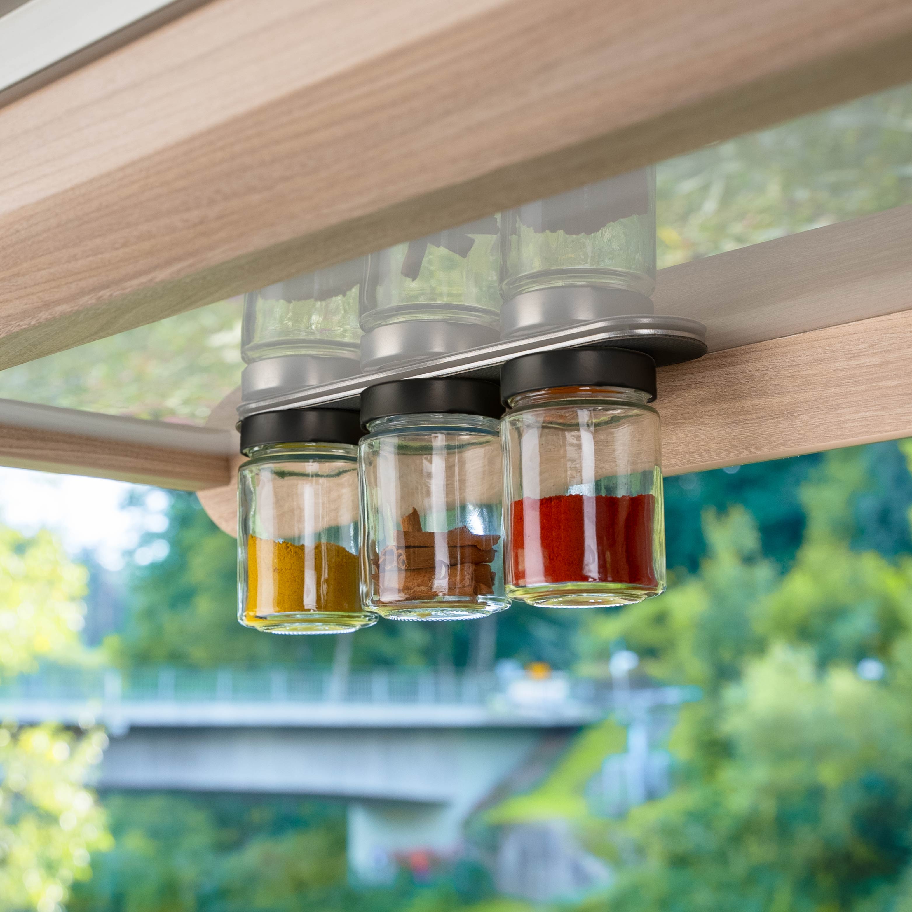 Pots à condiments magnétiques placés sur la barre dans le camping-car