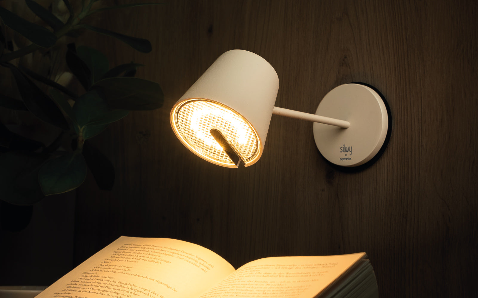 Immagine d'atmosfera con tavolo sompex e lampada da parete come luce di lettura